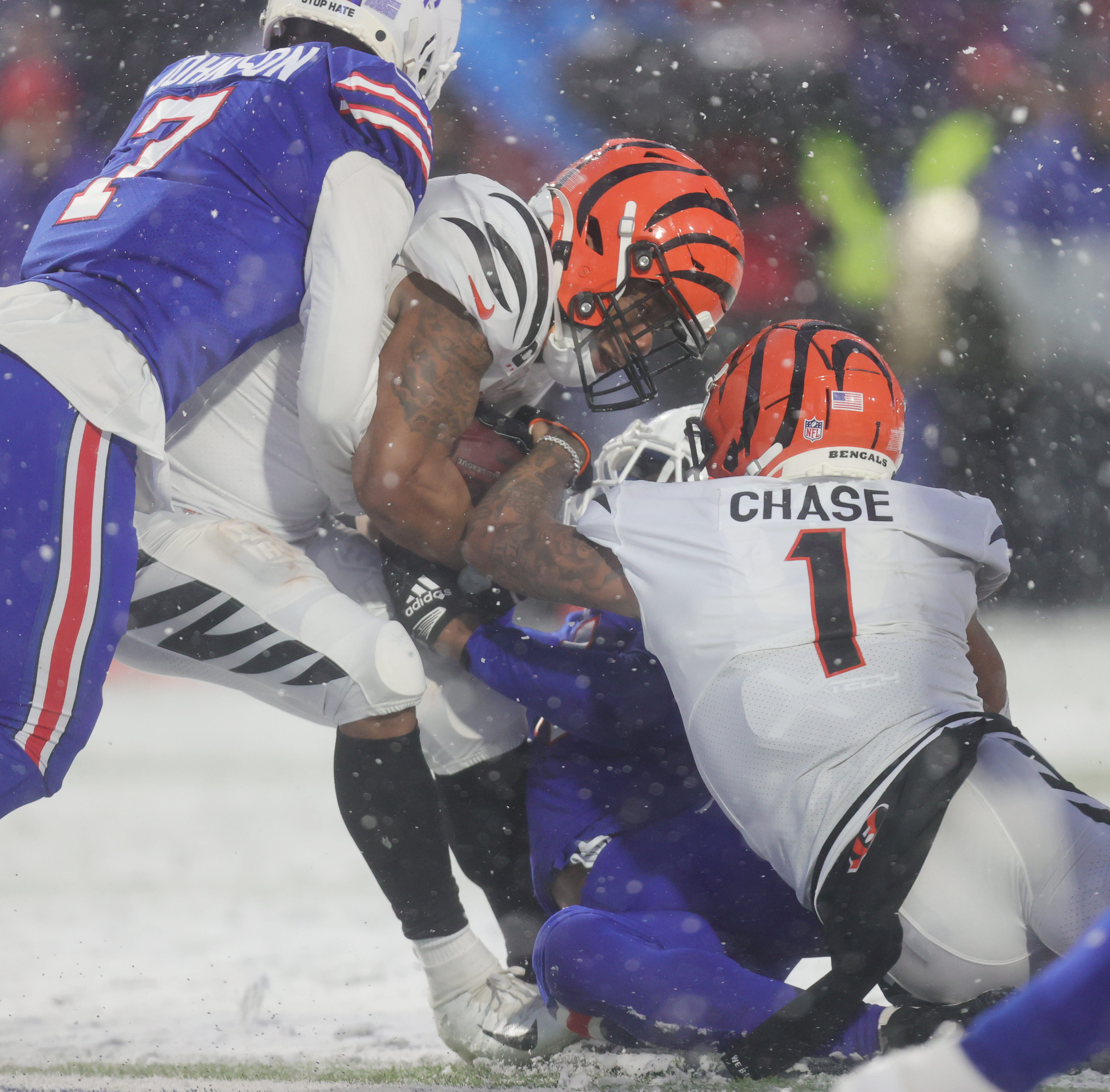 Cincinnati Bengals running back Joe Mixon (28) is tackled by the Buffalo  Bills during the first quarter of an NFL division round football game,  Sunday, Jan. 22, 2023, in Orchard Park, N.Y. (