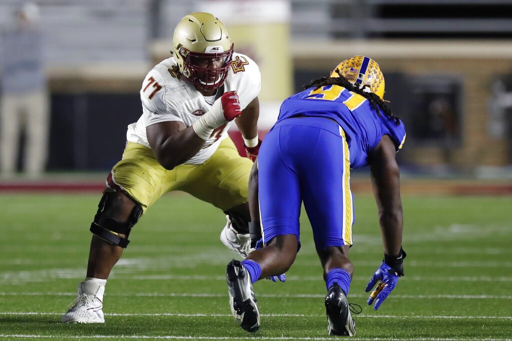 Boston College offensive guard Zion Johnson holds a team jersey