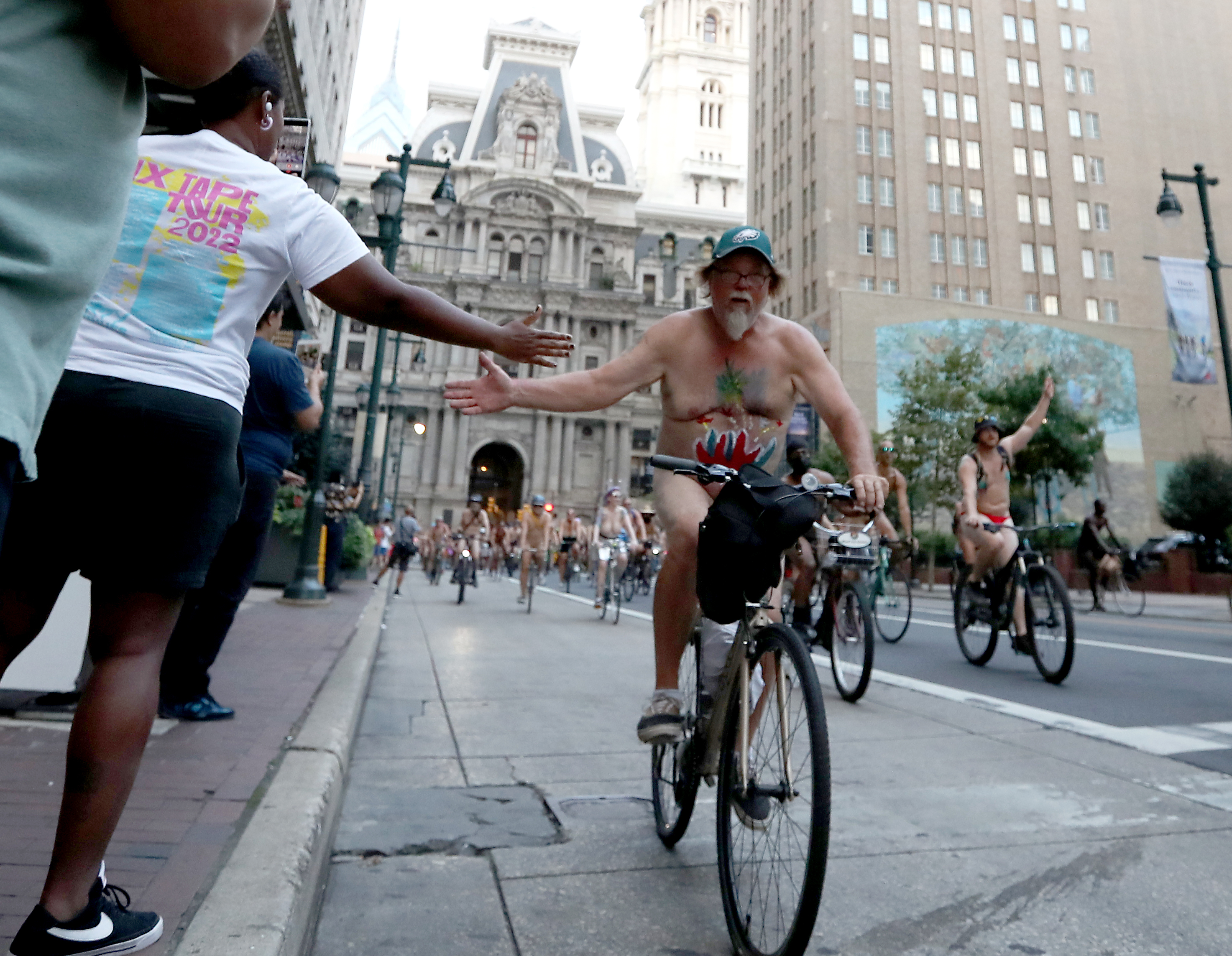 People ride bikes along Market Street in Philadelphia during the Philly Naked Bike Ride, Saturday, Aug. 27, 2022.