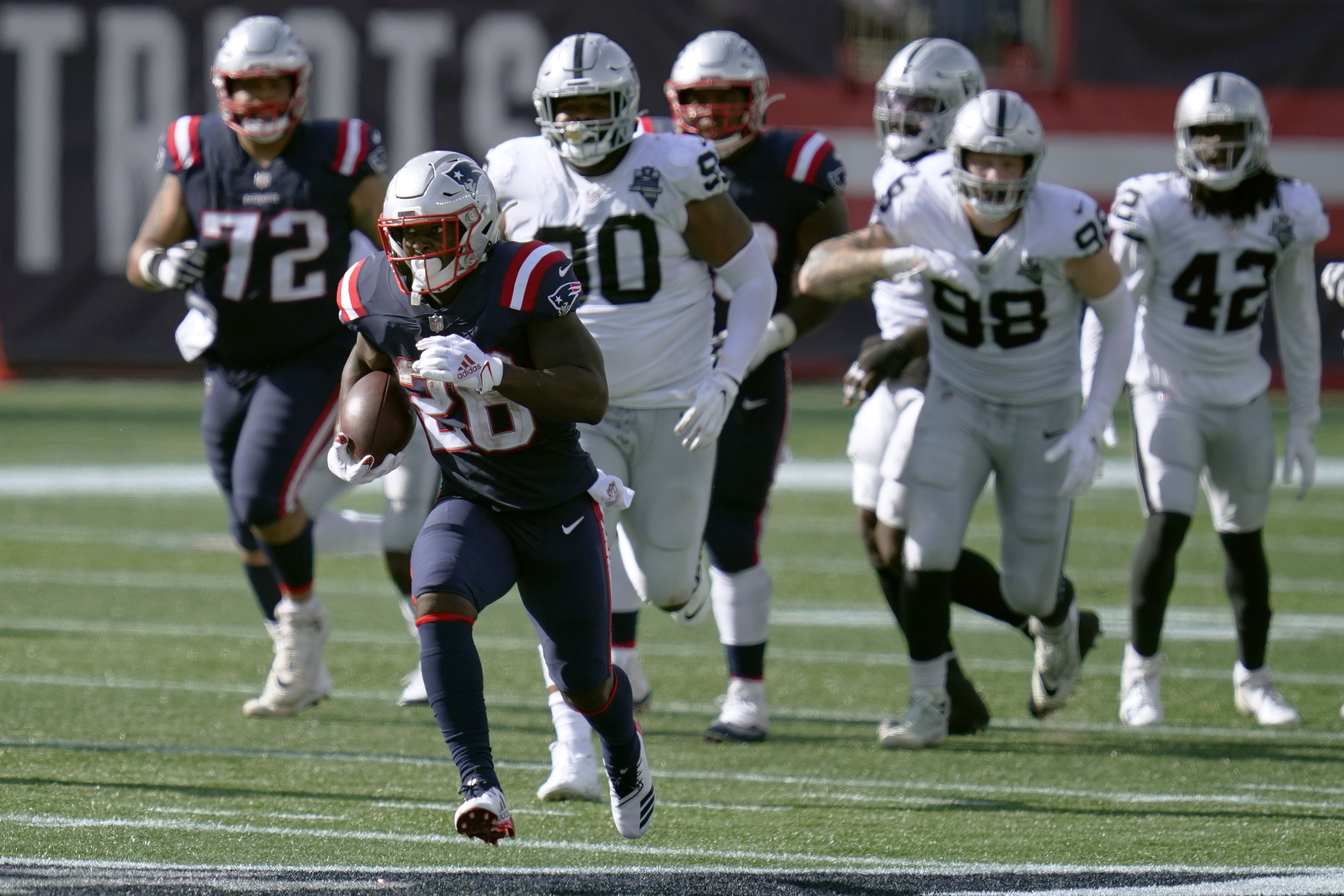 New England Patriots running back Sony Michel (26) tries to break free from  Las Vegas Raiders d …