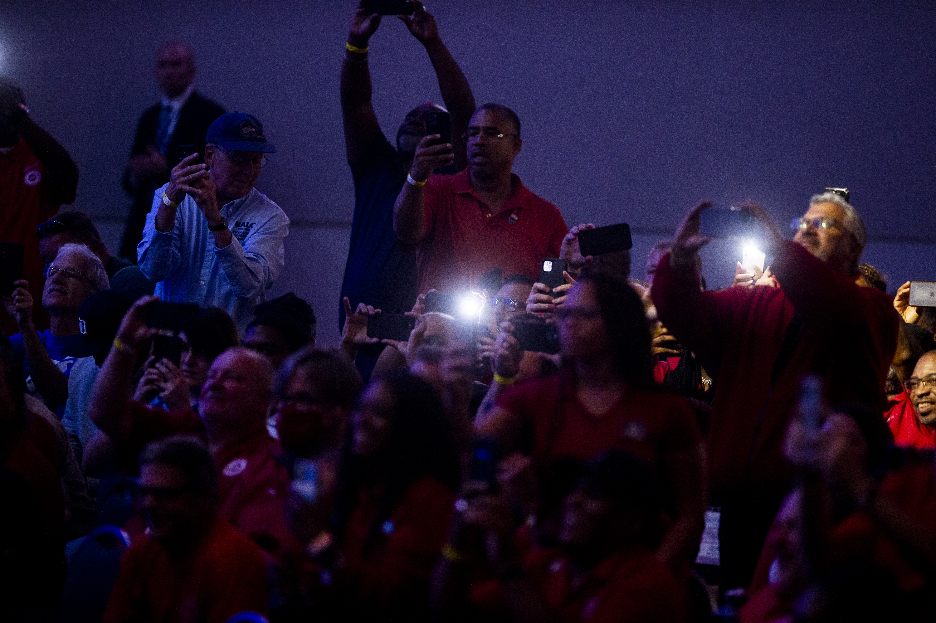 UAW members photograph as U.S. President Joe Biden speaks during the 2022 North American International Auto Show at Huntington Place in Detroit on Wednesday, Sept. 14 2022.