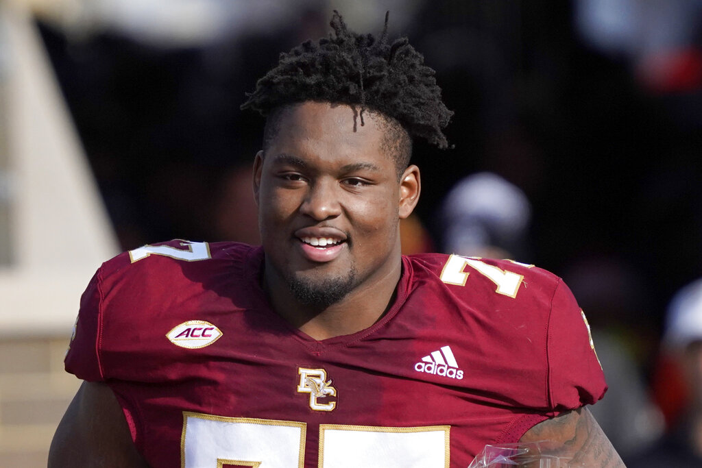 Boston College offensive guard Zion Johnson holds a team jersey