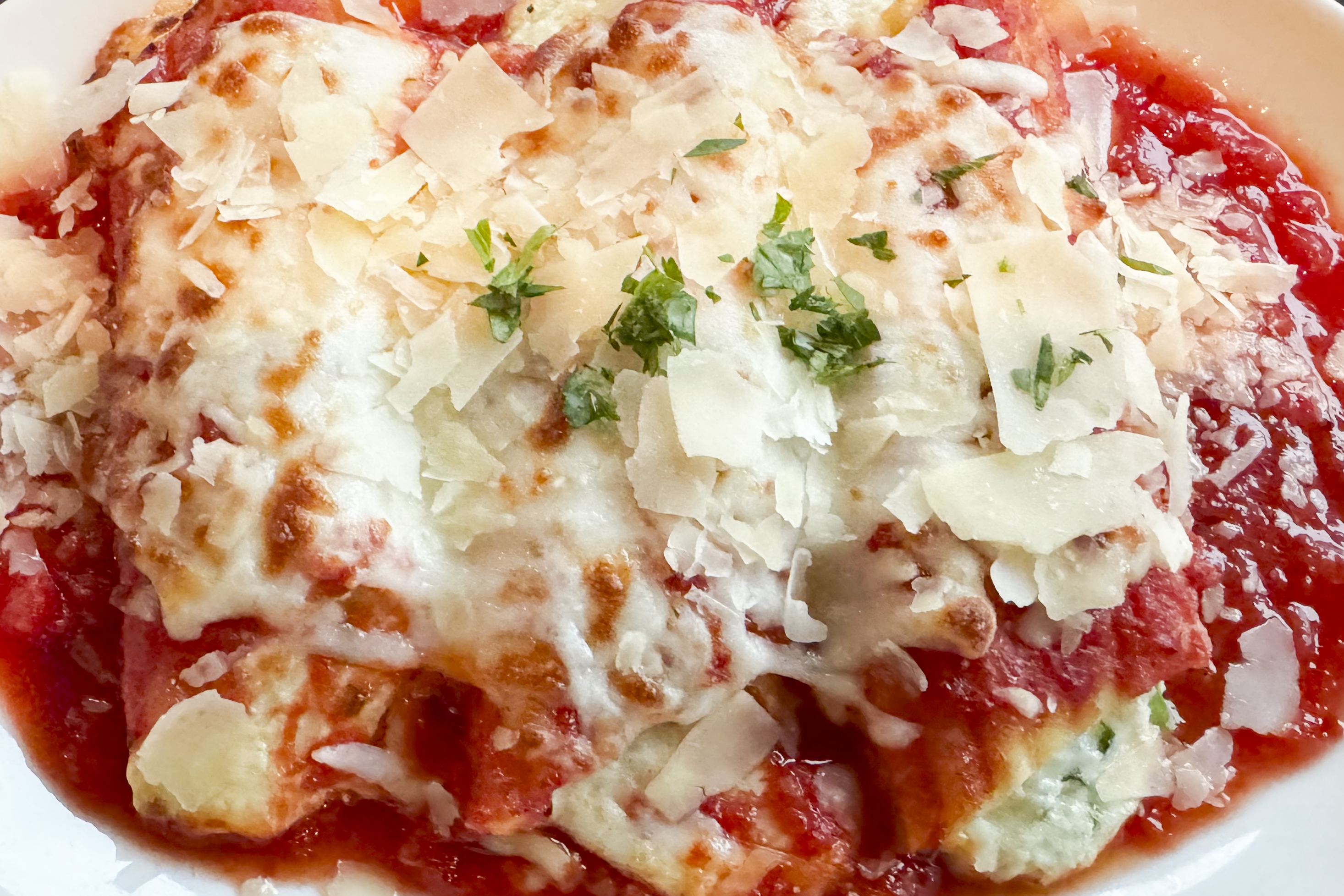 Baked 4 cheese manicotti—marinara, greens and herbs at Compass and Cleaver located at 12454 E D Ave. in Richland, Michigan.