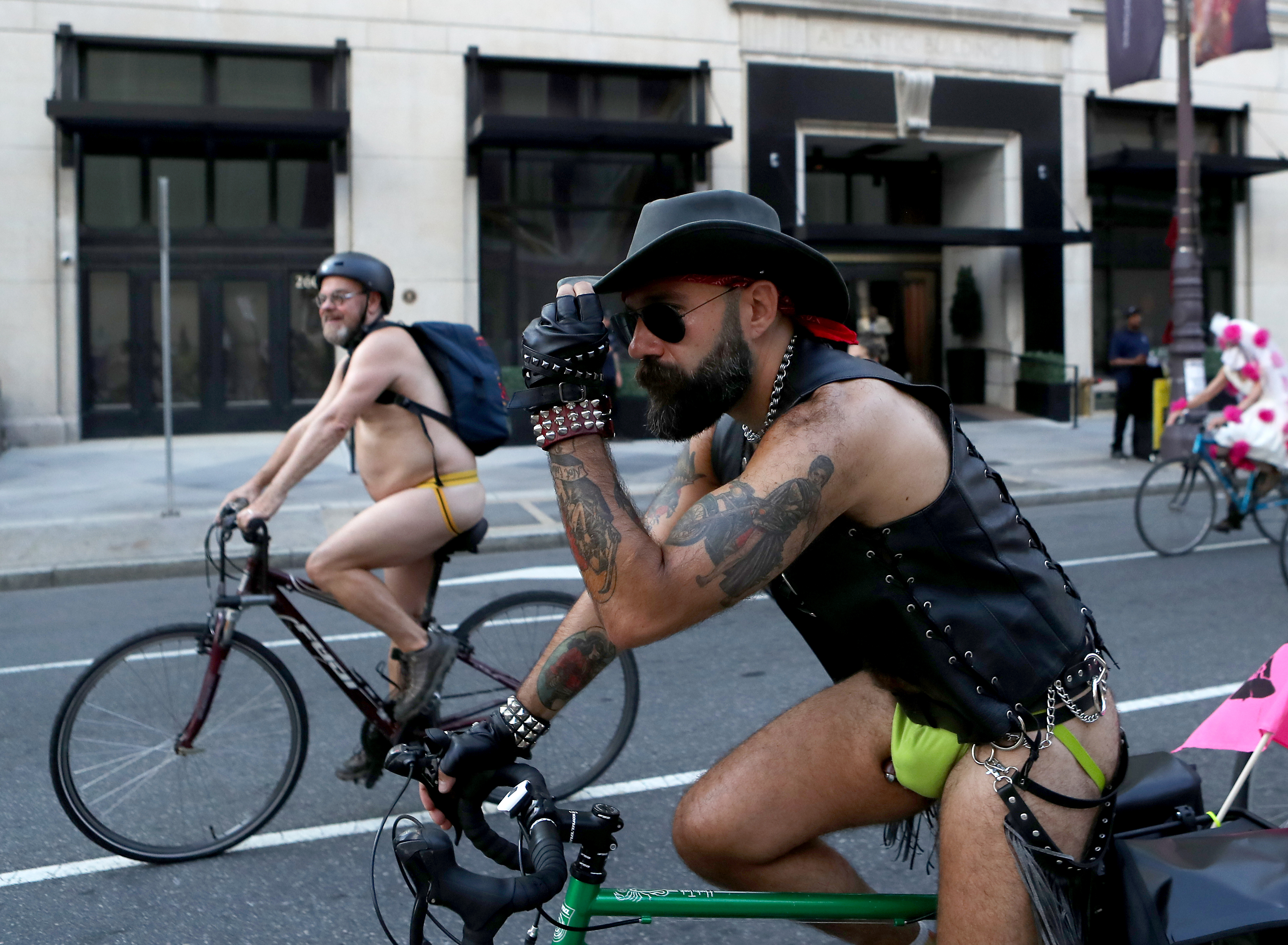 People ride bikes along South Broad Street in Philadelphia during the Philly Naked Bike Ride, Saturday, Aug. 27, 2022.