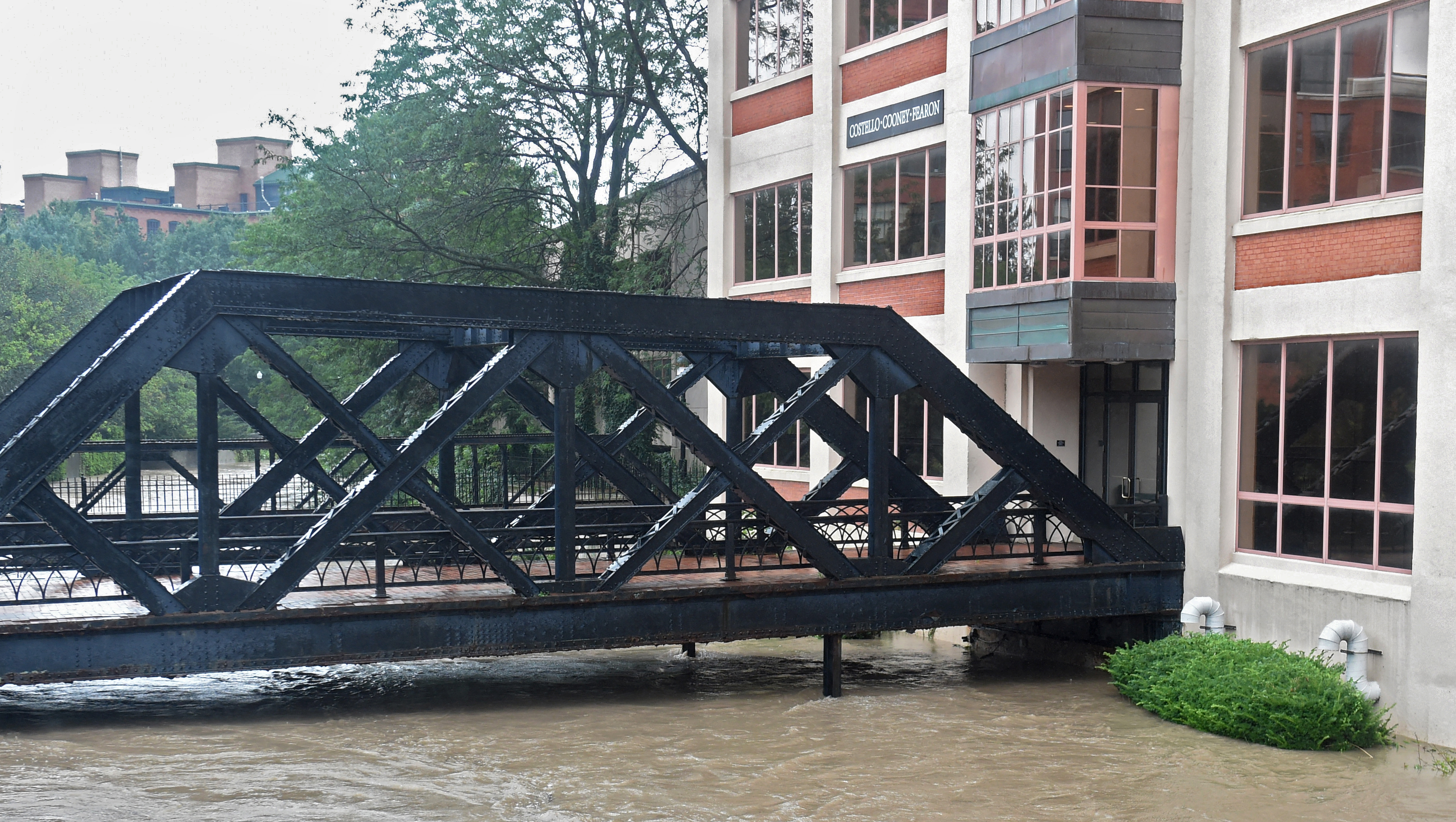 Heavy rains again caused flooding in Central New York August 19, 2021. High waters in Onondaga Creek flow under the bridge in Franklin Square, nearly touching the bottom.