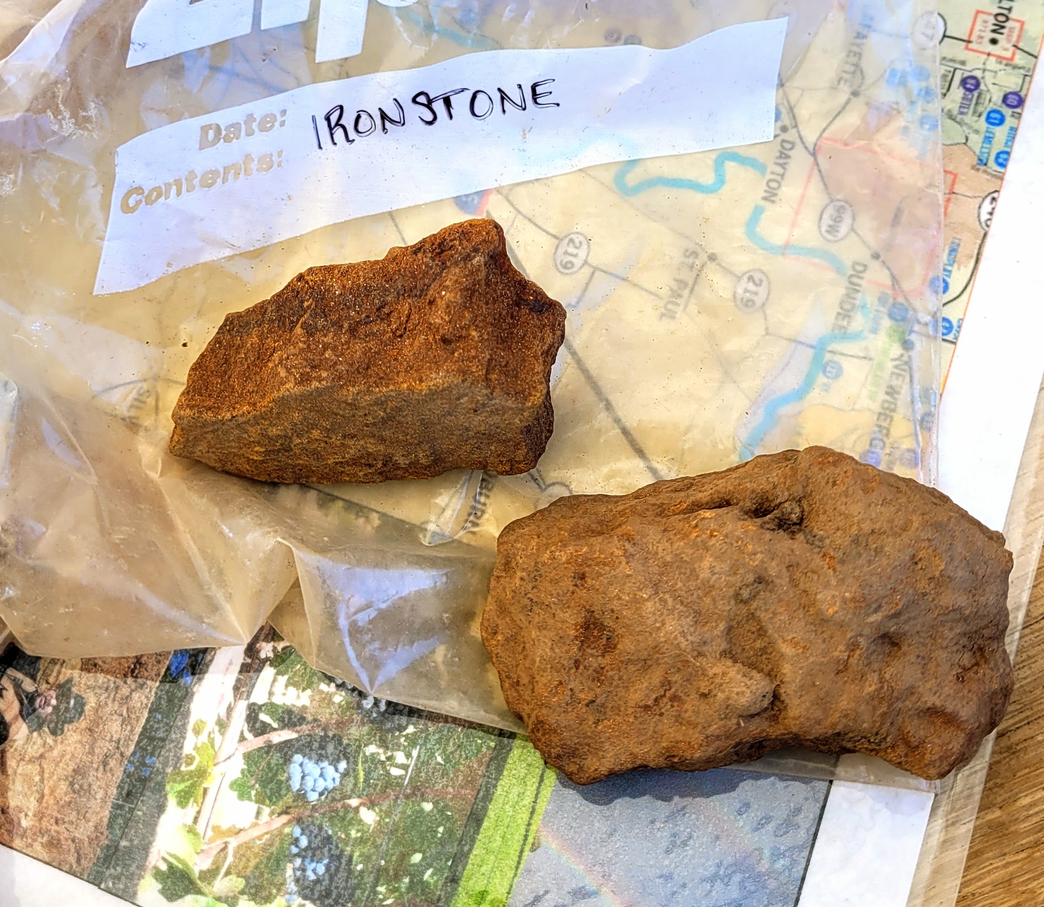 Two pieces of ironstone sit on a plastic bag.