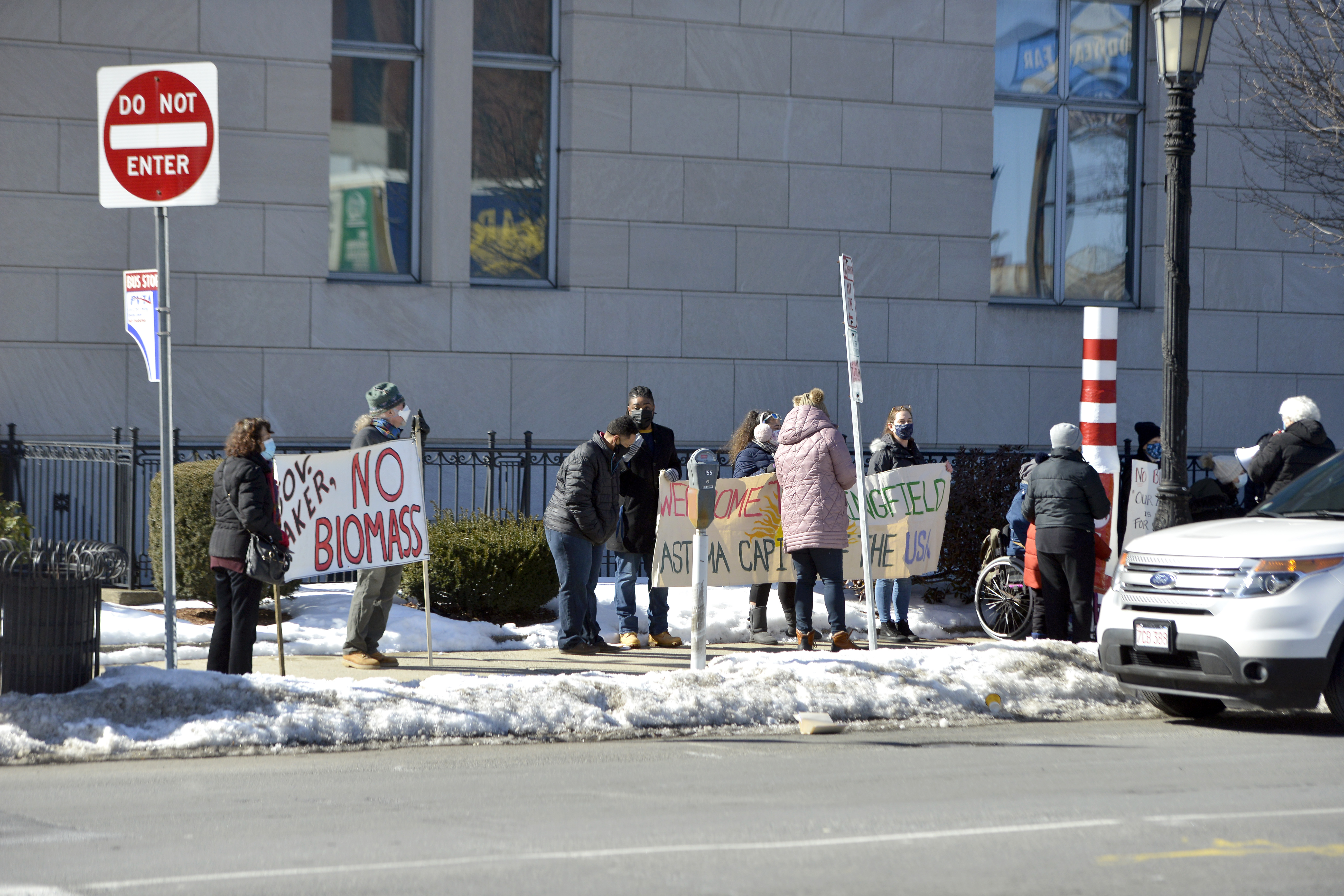 Demonstrators line the sidewalk outside the Western Massachusetts office of Governor Charlie Baker in Springfield to demand an end to the long proposed biomass energy plant in East Springfield on Feb. 17, 2021.   (Don Treeger / The Republican)