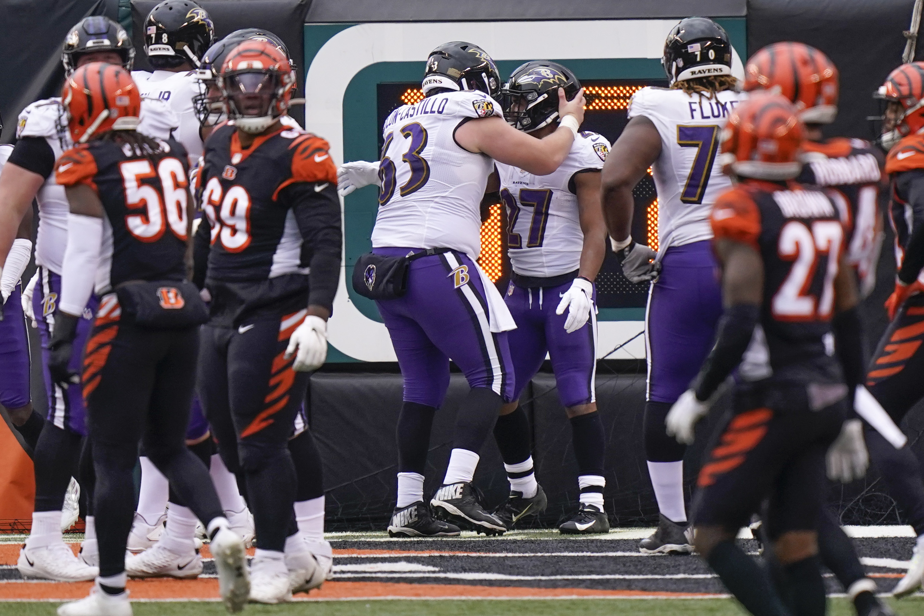 Baltimore Ravens running back J.K. Dobbins (27) takes a handoff from  quarterback Lamar Jackson …