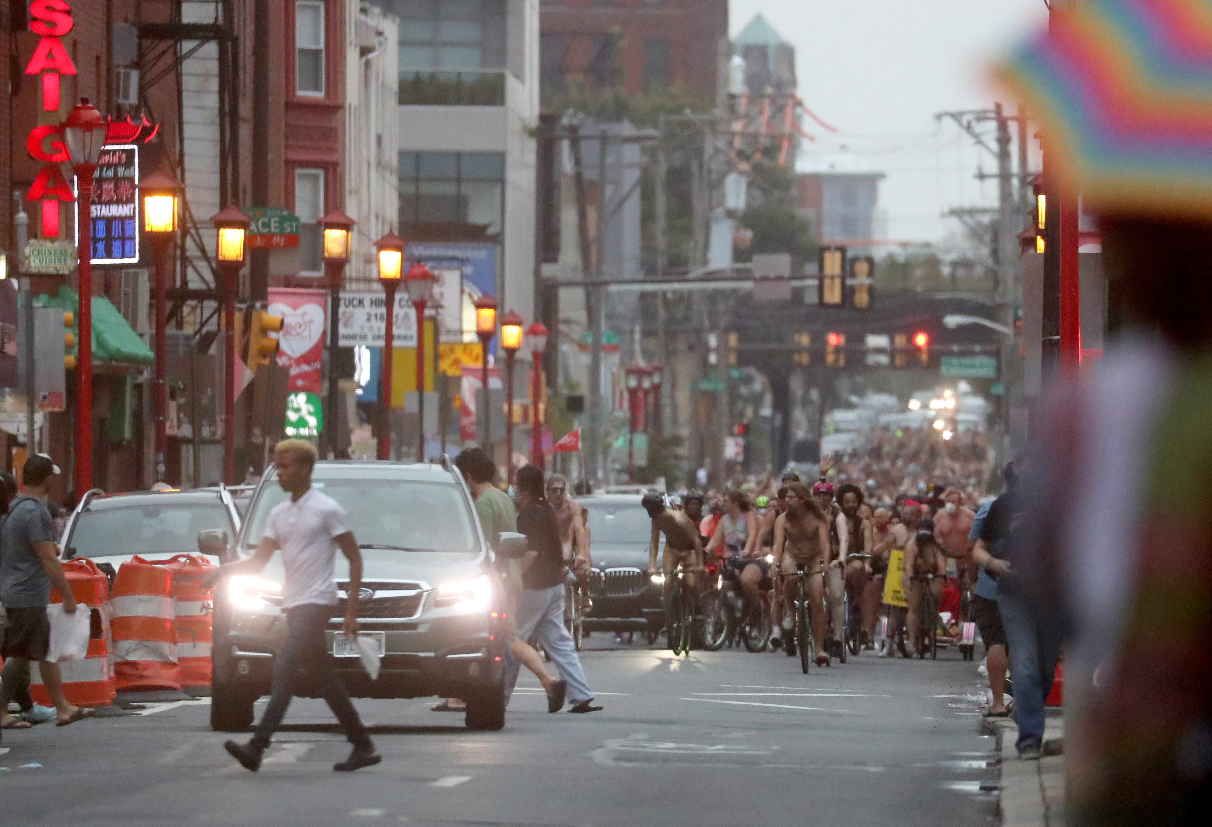 People ride bikes along 10th Street in Philadelphia during the Philly Naked Bike Ride, Saturday, Aug. 28, 2021.