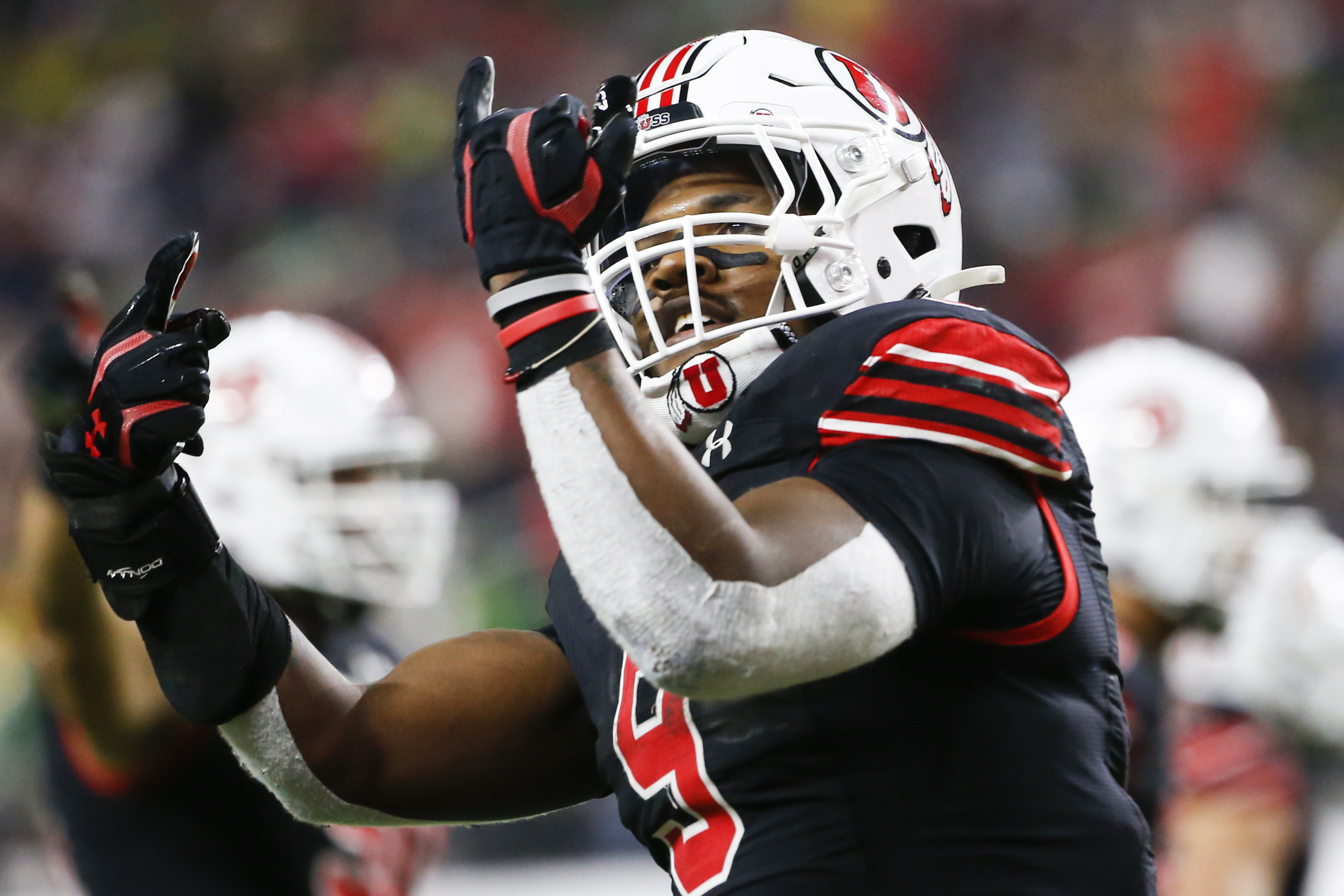 Utah linebacker Devin Lloyd holds a team jersey after he was