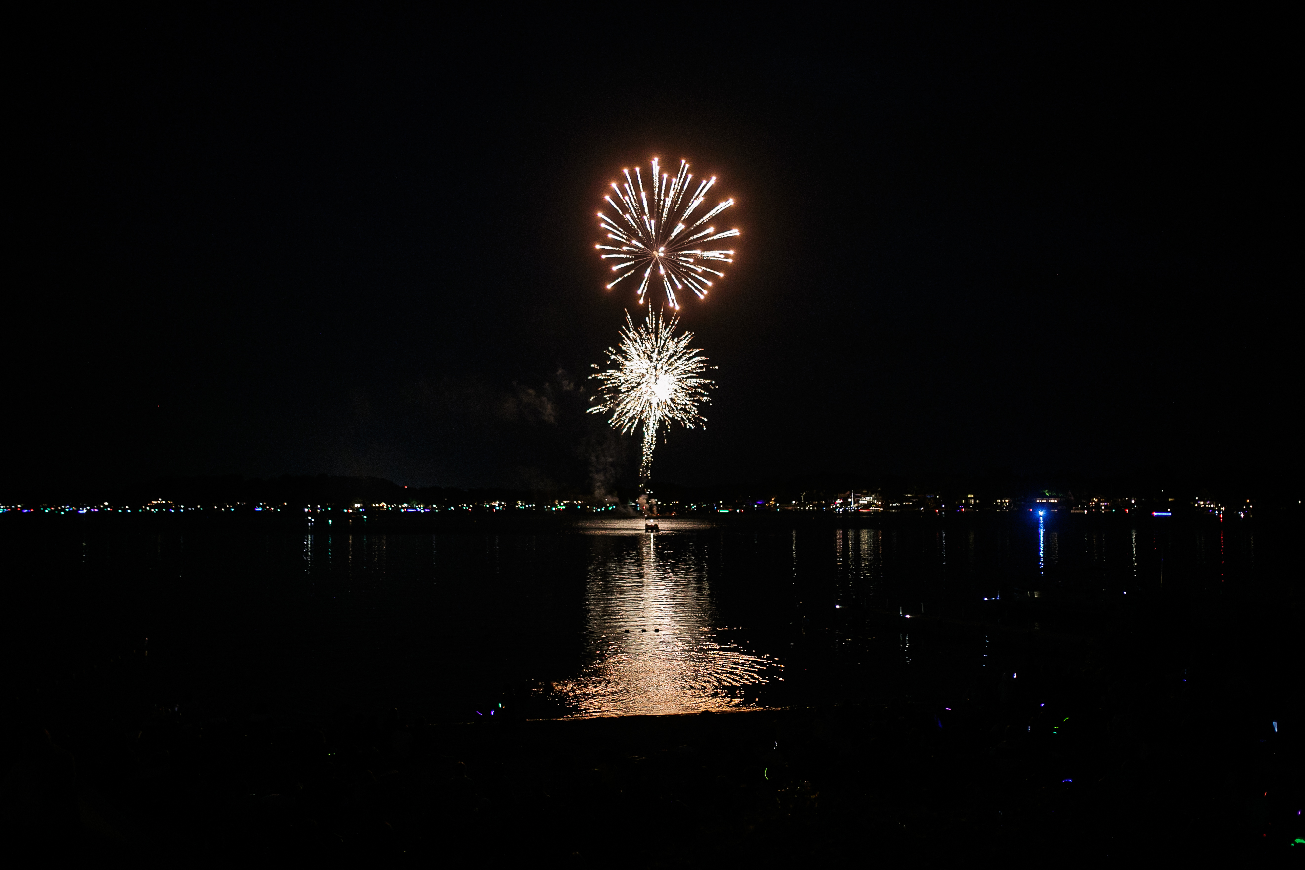 Fireworks blast off from a barge in the middle of the lake during the annual Lake Fenton Fireworks on the water in front of the Township hall on Saturday, June 2, 2022 in Fenton Township. (Jenifer Veloso | MLive.com)

