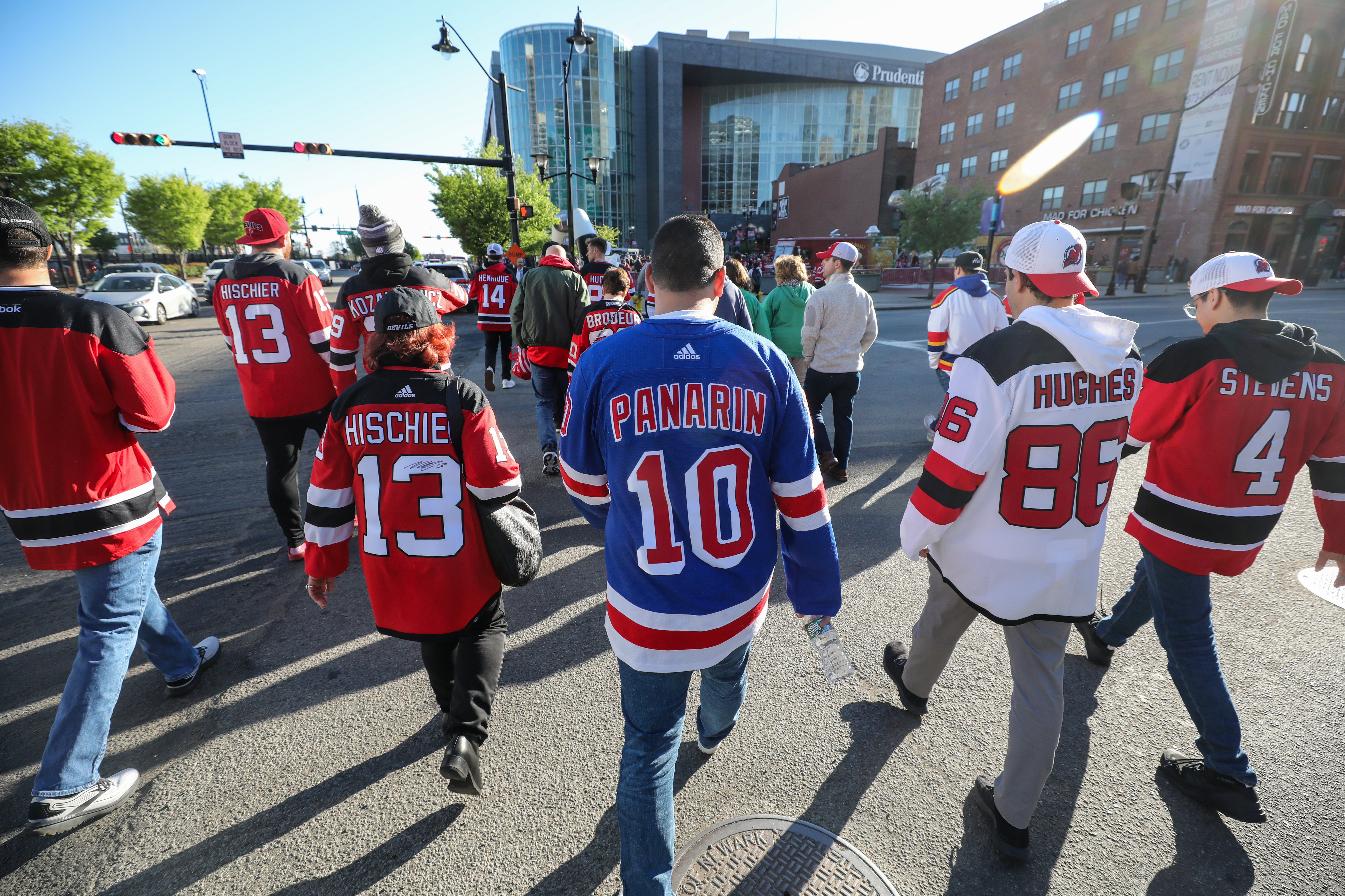 Fans walk along Market Street toward Prudential Center after getting off a train at Newark Penn Station on Tuesday, April 18, 2023 in Newark, N.J. The New York Rangers beat the New Jersey Devils, 5-1, in Game 1 of the NHL Stanley Cup playoffs.