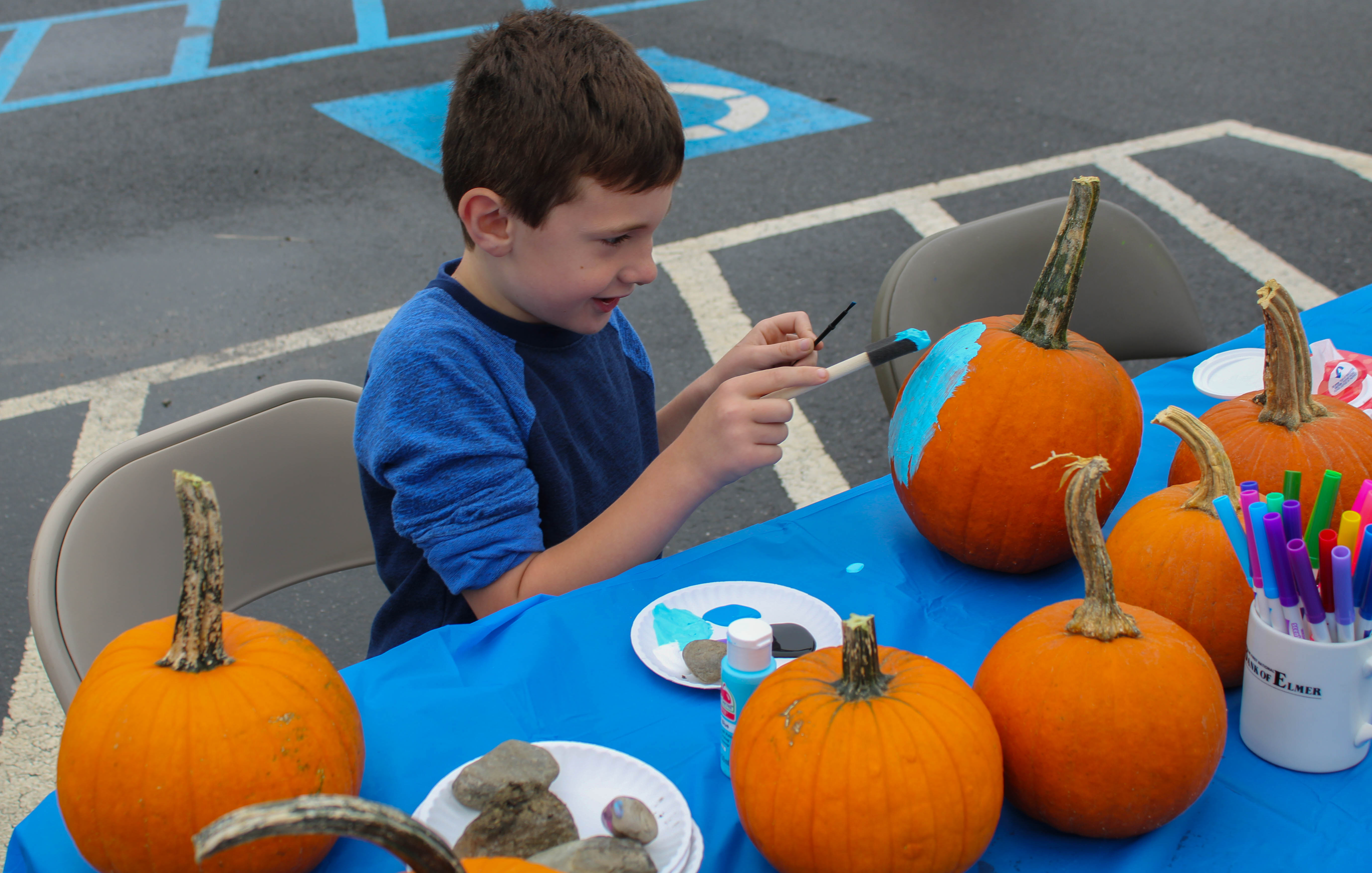 Six-year-old Aidan Young paints pumpkins at Harvest Day Festival in Elmer, Saturday, Oct. 1, 2022.