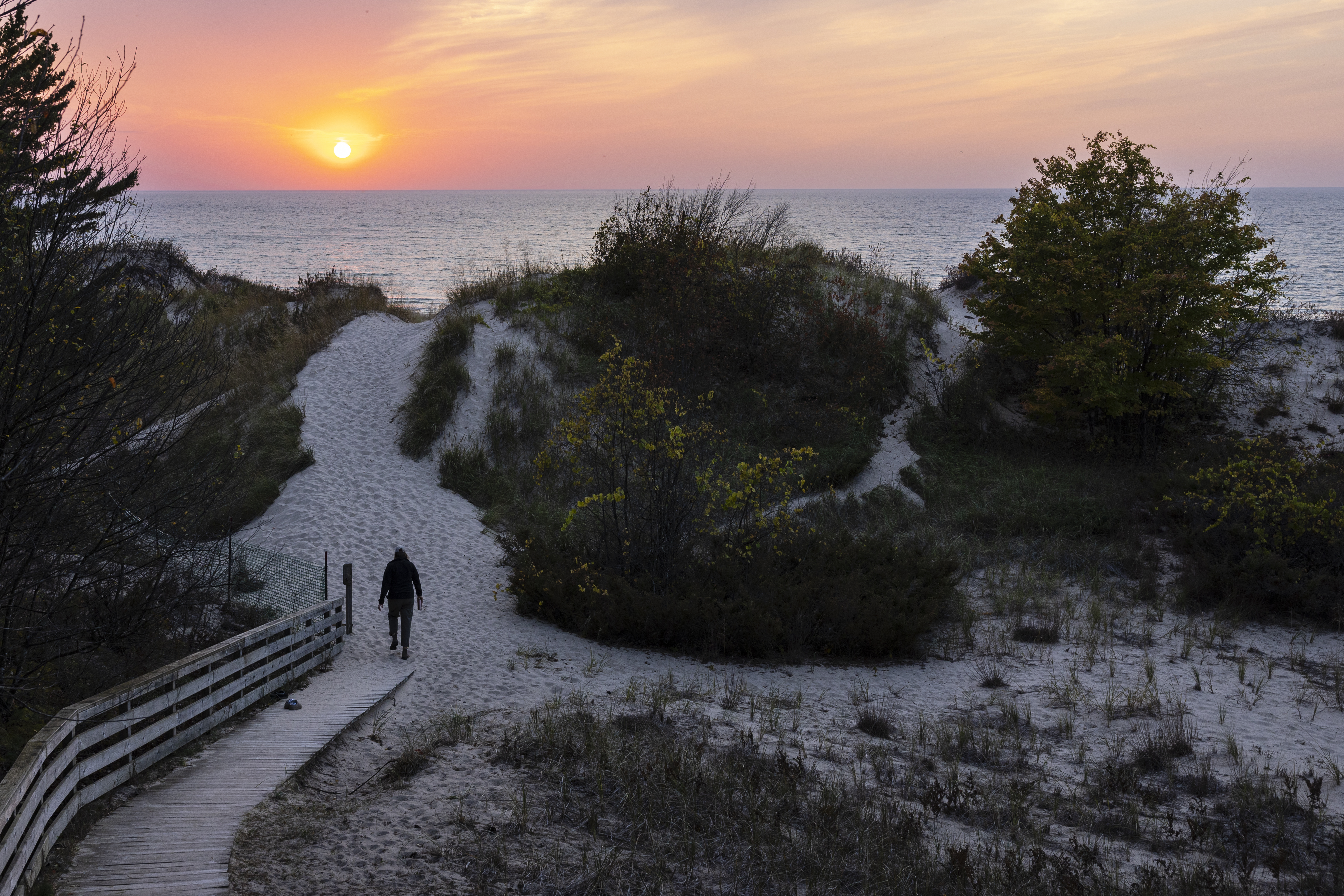 The sun sets over Lake Michigan at Nordhouse Dunes Wilderness Area in Mason County, Mich. on Friday, Oct. 11, 2024.  