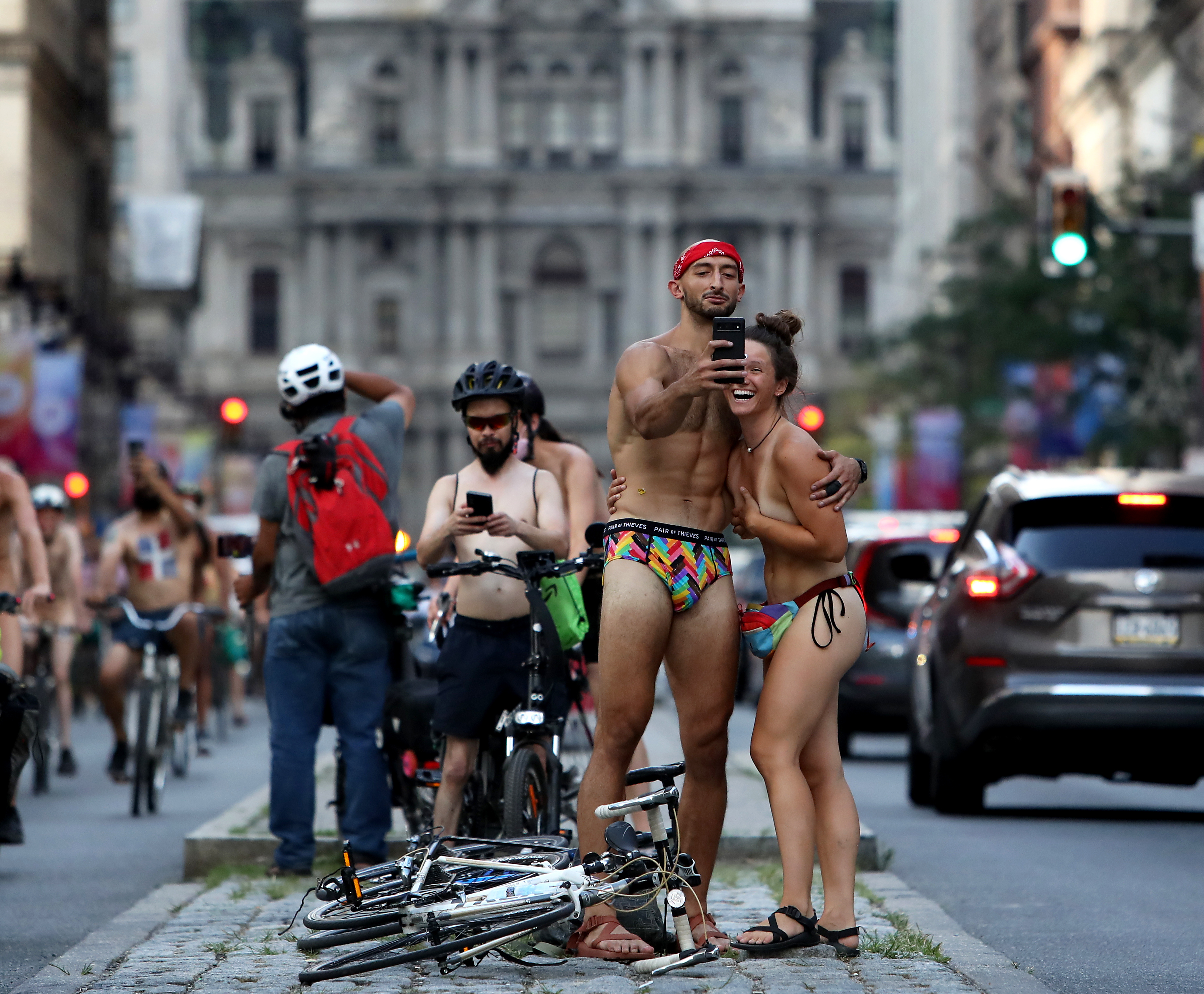 Philly Naked Bike Ride participants stop to take a selfie along South Broad Street in Philadelphia, Saturday, Aug. 27, 2022.