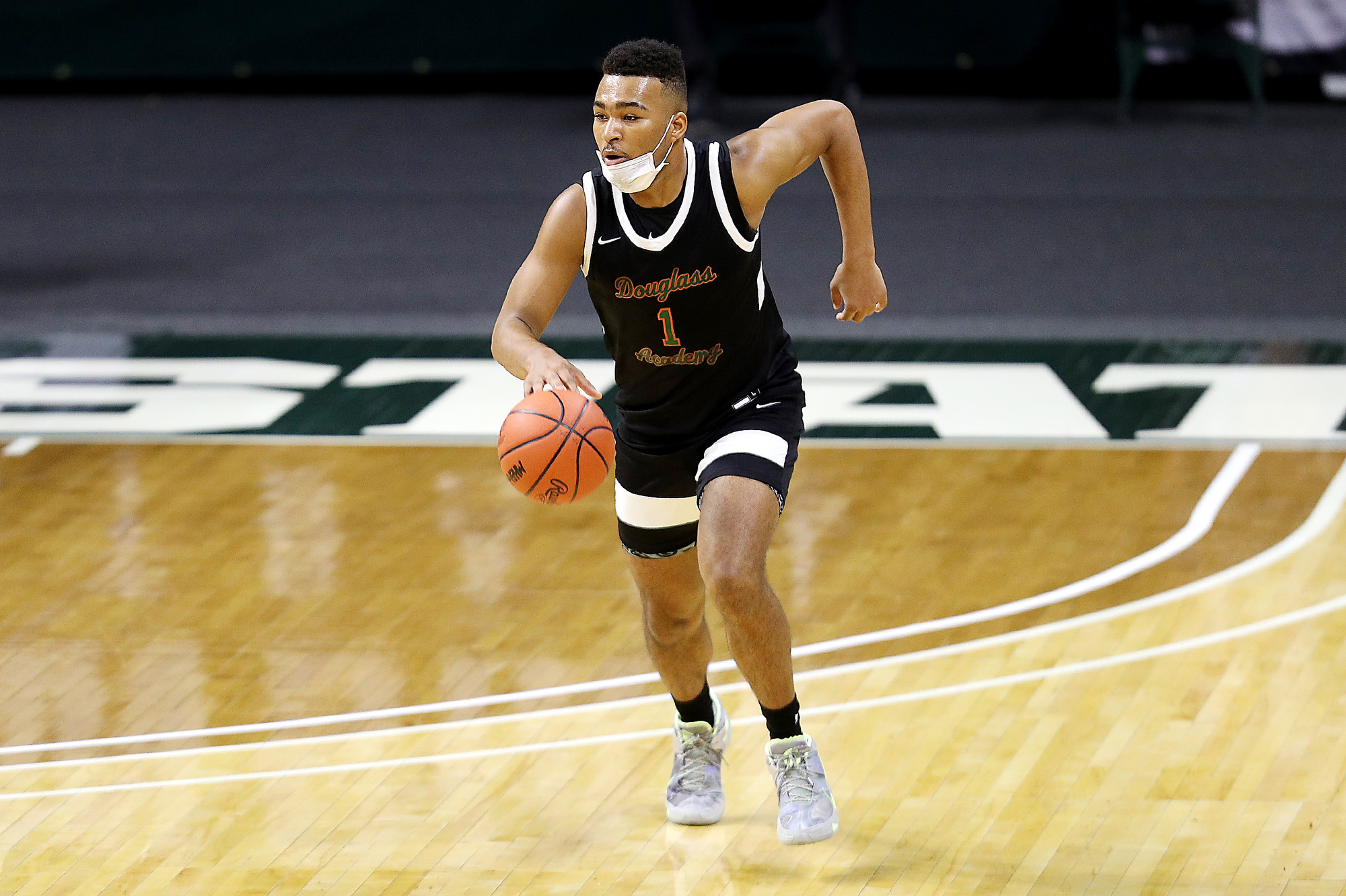 Photos of Detroit Douglass basketball player Pierre Brooks II