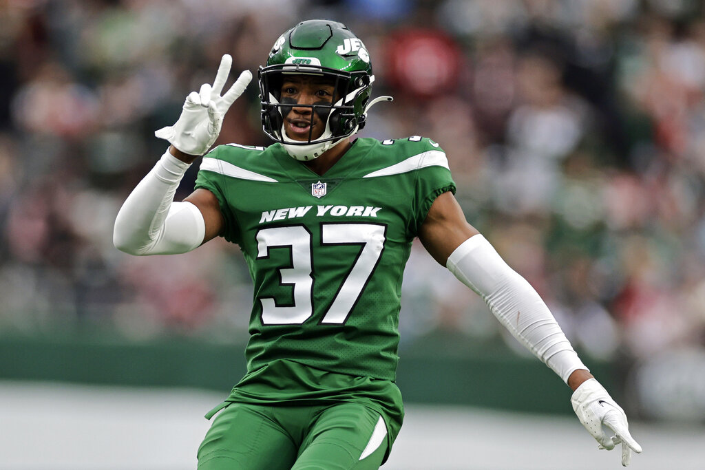 New York Jets' Bryce Hall, left, tackles New England Patriots' Hunter Henry  during the second half of an NFL football game, Sunday, Sept. 19, 2021, in  East Rutherford, N.J. (AP Photo/Bill Kostroun