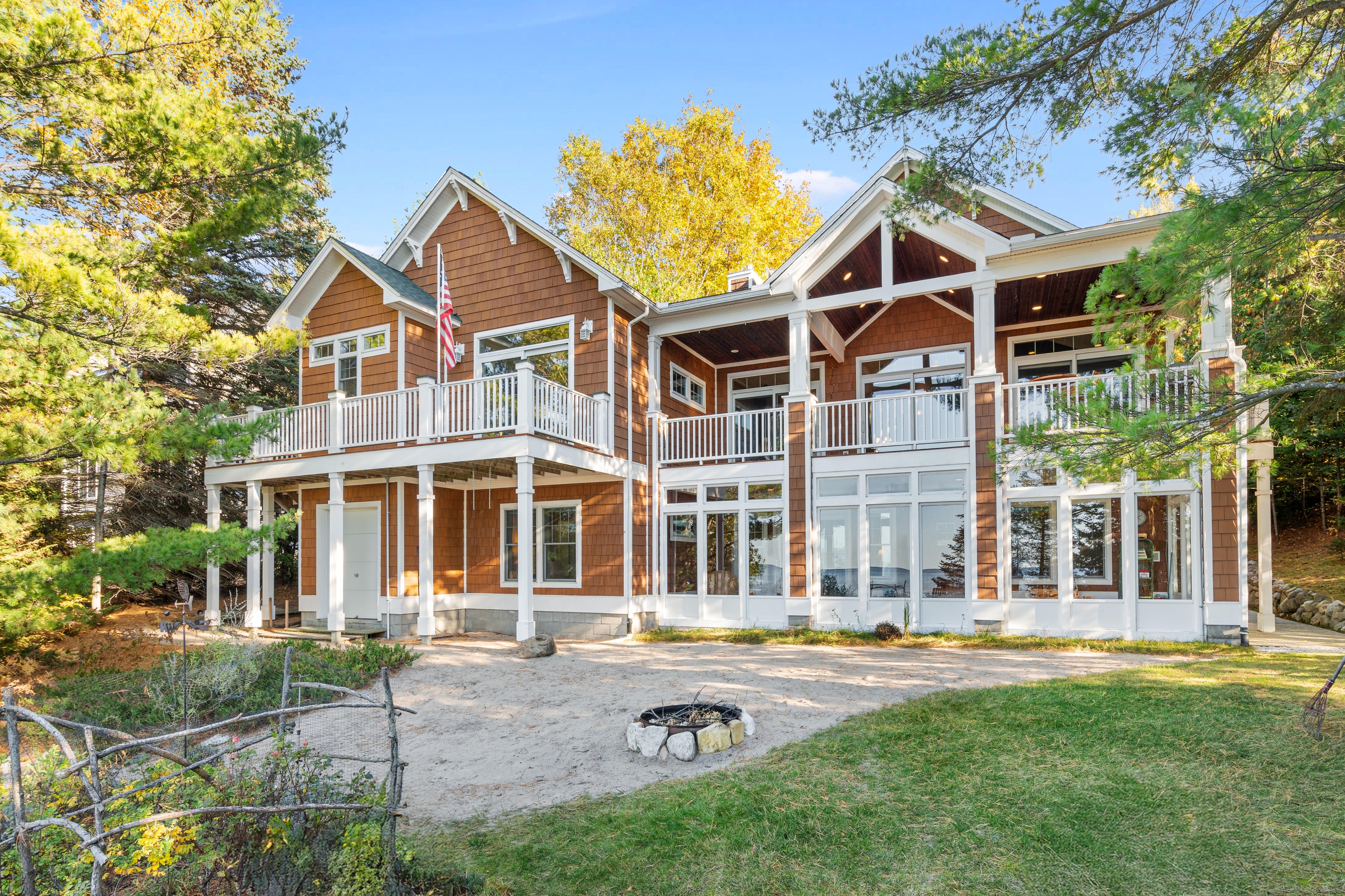 Exterior photographs of 4093 Lake Shore Drive in Charlevoix, this gem is listed at $2,099,900 through Berkshire Hathaway HomeServices Michigan Real Estate – Traverse City and The Crane Group with associate broker Johnny Crane and his brother, co-listing agent Matt Crane.