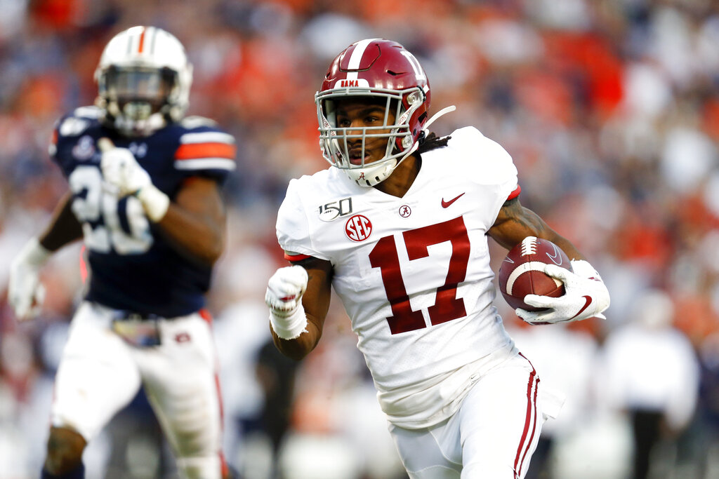 FILE - In this Saturday, Sept. 26, 2020, file photo, Alabama wide receiver Jaylen  Waddle, center, pulls down a reception between Missouri's Tyree Gillespie,  right, and Ishmael Burdine, left, during the first