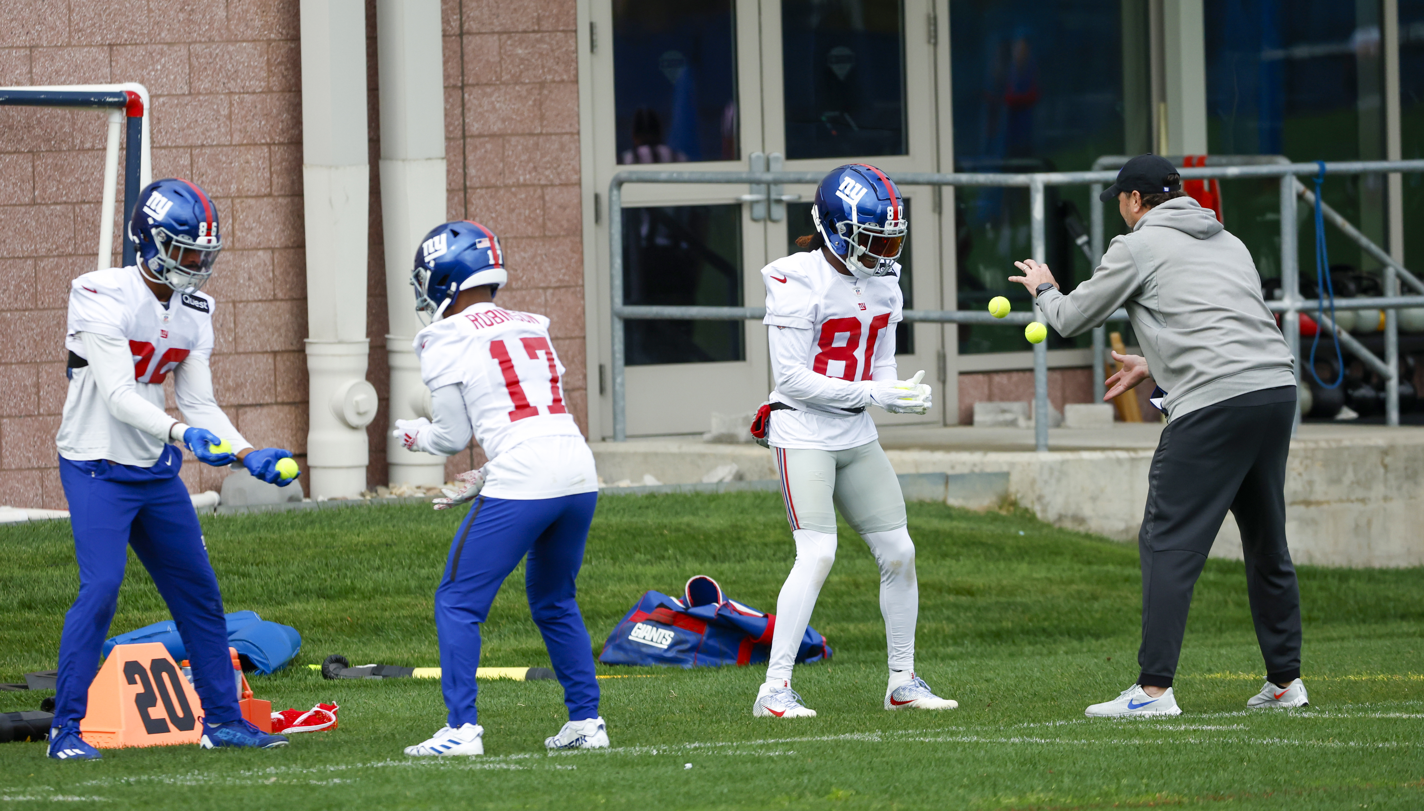 New York Giants wide receivers Darius Slayton (86), Wan'Dale Robinson (17), Richie James (80) and wide receivers coach Mike Groh work with tennis balls during practice on Wednesday, Oct. 26, 2022. 