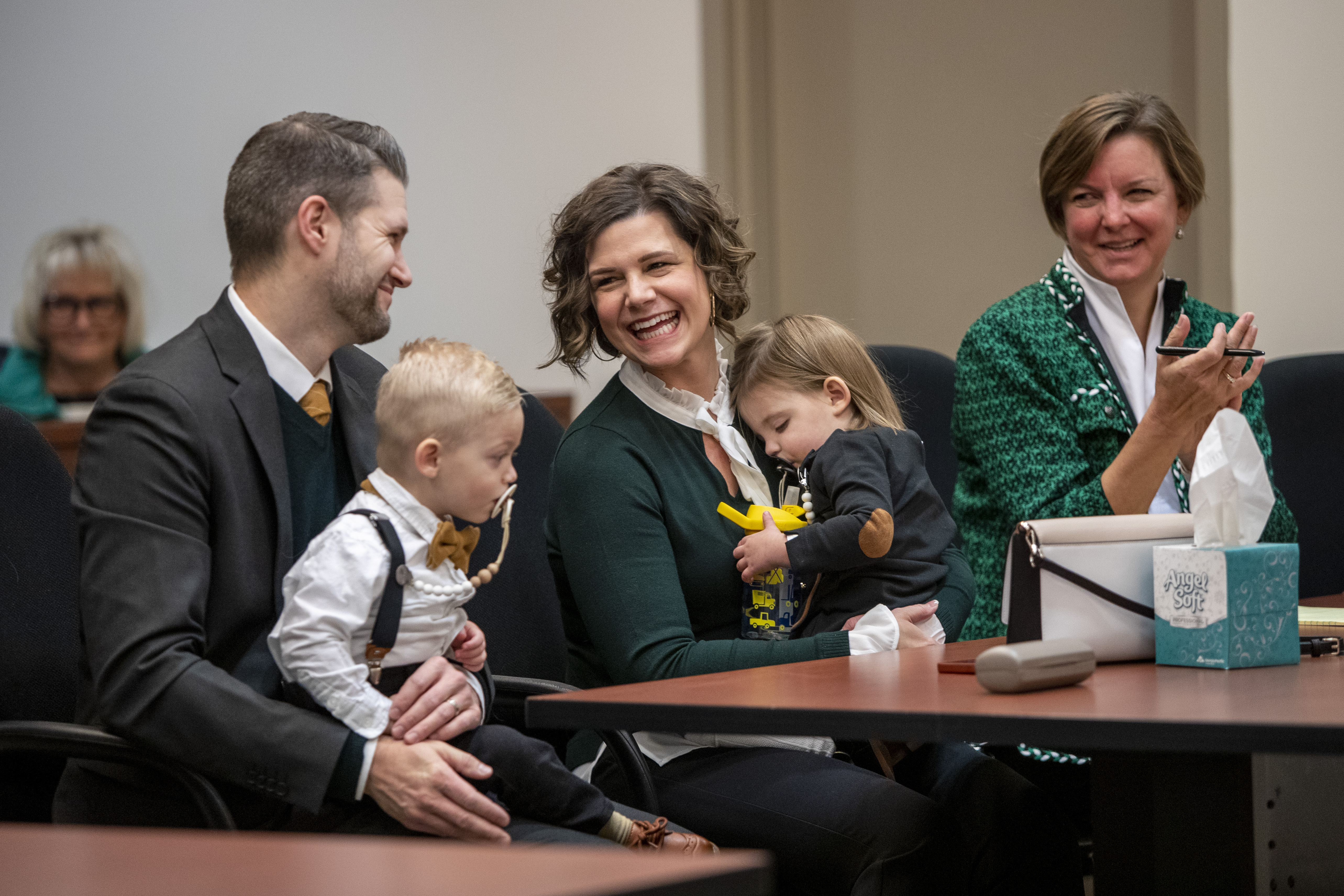 Tammy and Jordan Myers hold their twins, Eames, left, and Ellison, during Adoption Day at the Kent County Courthouse in Grand Rapids on Thursday, Dec. 8, 2022. Also pictured is their attorney, Melissa Neckers, far right. Tammy and Jordan are the biological parents of the 1-year-old twins. Lauren Vermilye, a surrogate, gave birth to the twins after Tammy went through breast cancer treatment and has no claim to the babies. The Myers family was able to adopt the twins after convincing the court system to grant them custody. (Cory Morse | MLive.com)