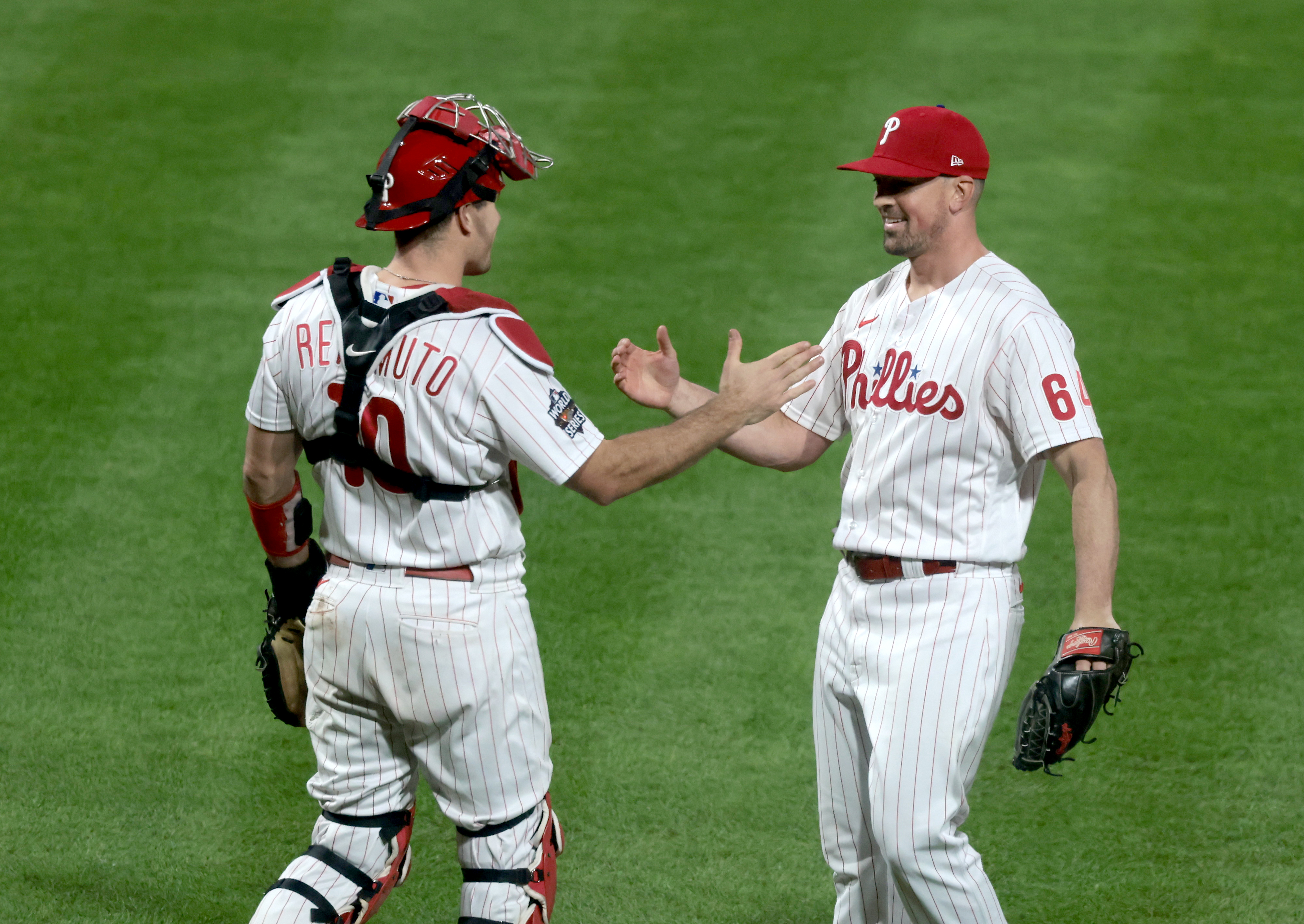 Andrew Bellatti (64) of the Philadelphia Phillies and J.T. Realmuto (10) celebrate after the final out in a 7-0 victory vs. the Houston Astros in Game 3 of the World Series at Citizens Bank Park, Tuesday, Nov. 1, 2022.