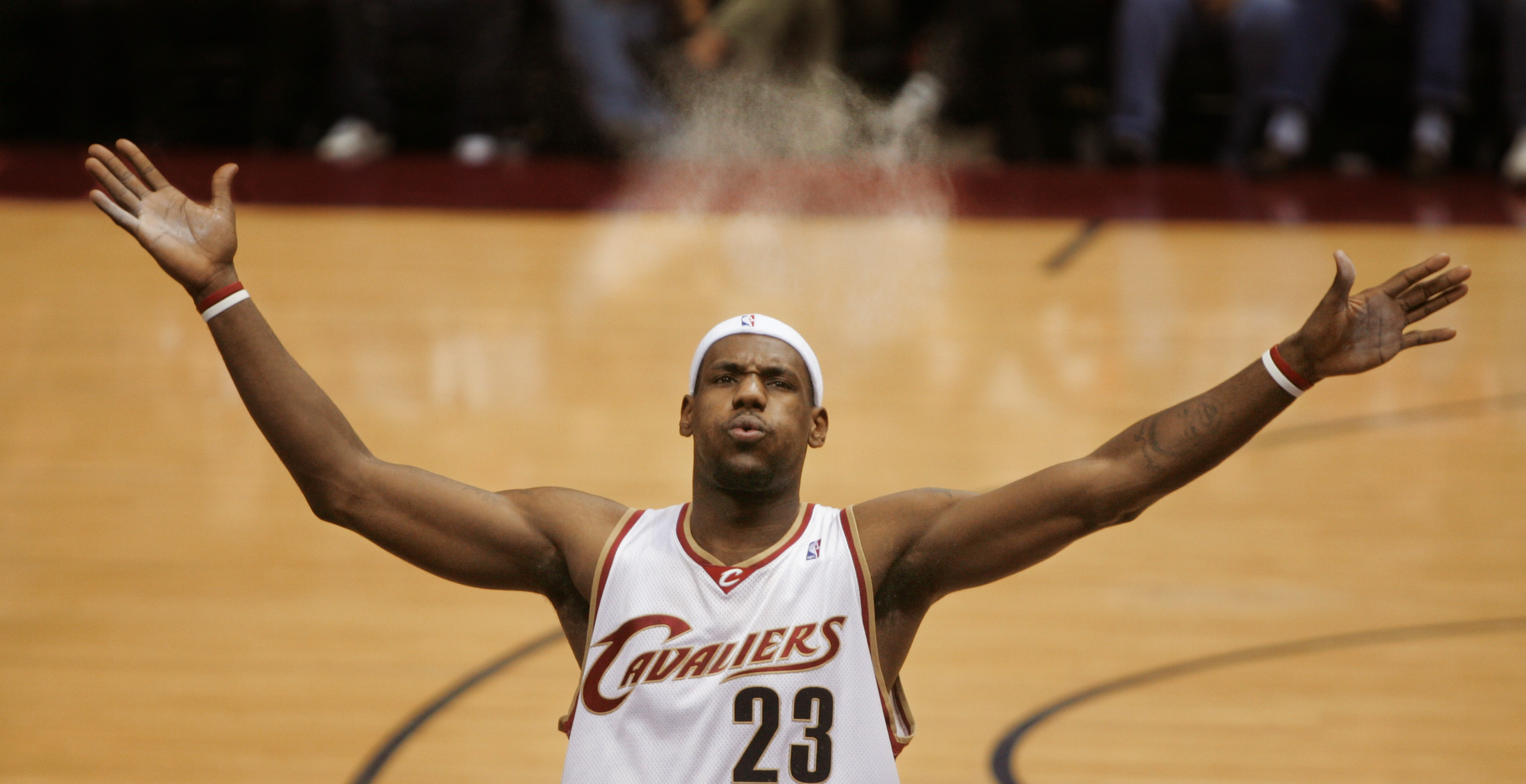 The Cleveland Cavaliers LeBron James sends talc powder in the air as he blows it away from his face before a game against the Orlando Magic February 21, 2006 at Quicken Loans Arena.  The powder blast is a pre-game ritual for LeBron and the first row of media usually gets some of the residue.   (John Kuntz/The Plain Dealer) 