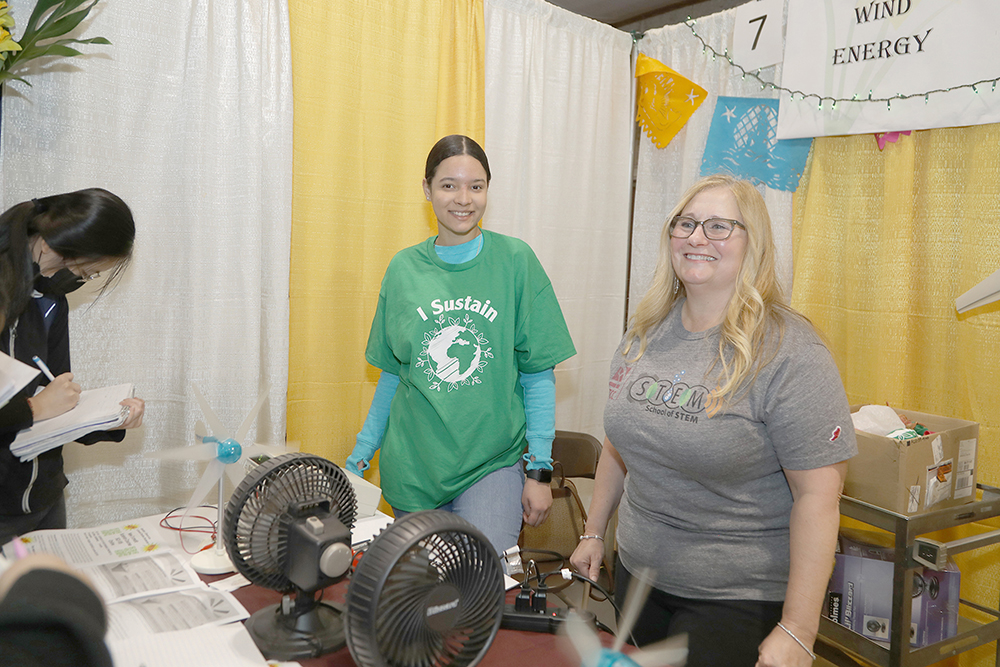 L to R- STCC student Aida Dominguez and Professor Barbara Washburn spoke to students about the Renewable energy of Wind at the Sustainathon event taking place in the gym in building 2 at Springfield Technical Community College on April 11th. (Ed Cohen Photo)