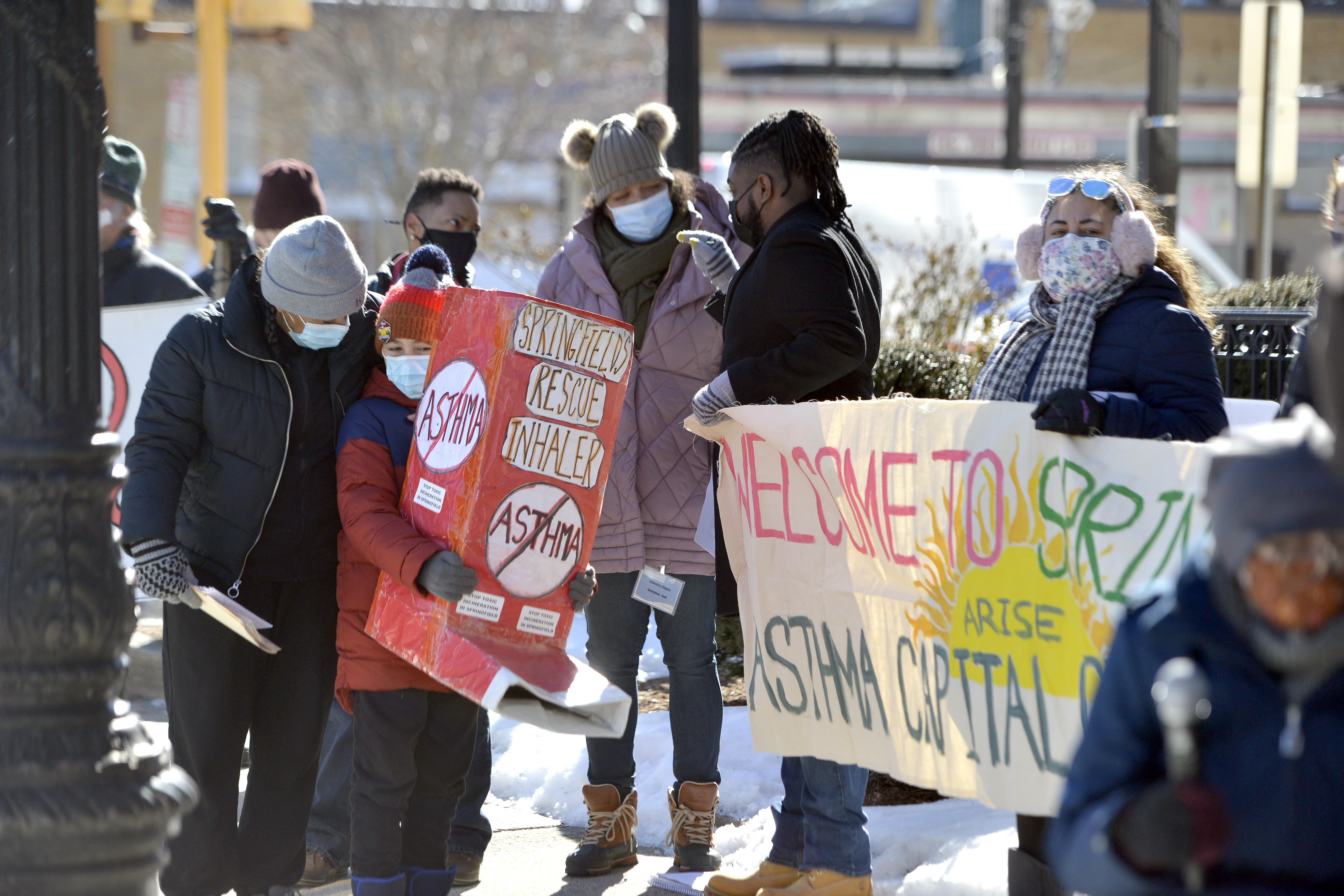 Demonstrators stand outside the Western Massachusetts office of Governor Charlie Baker in Springfield to demand an end to the long proposed biomass energy plant in East Springfield on Feb. 17, 2021.   (Don Treeger / The Republican)