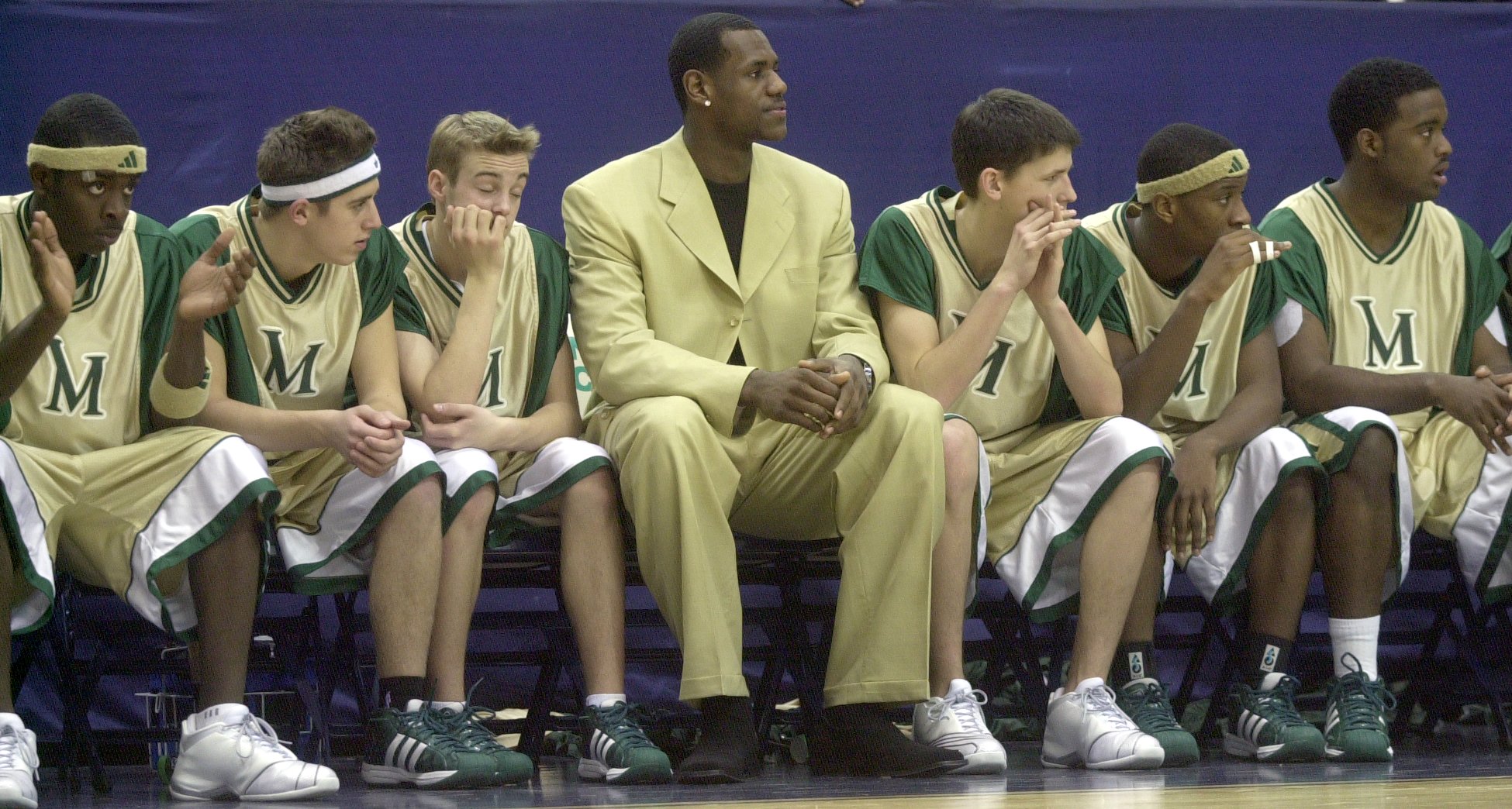 St. Vincent-St. Mary High School basketball star LeBron James sits on the bench during their game against Canton McKinley Sunday, Feb. 2, 2003, Akron, Ohio.  James has been declared ineligible by the OHSAA.  (Dale Omori/The Plain Dealer)