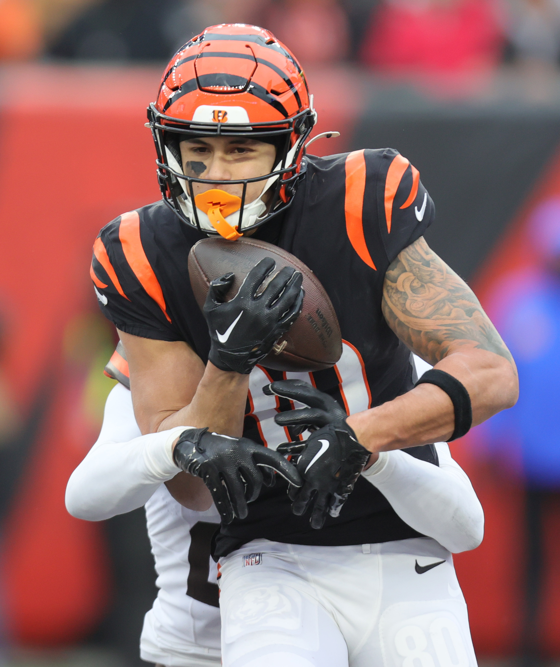 Cincinnati Bengals wide receiver Andrei Iosivas secures a touchdown pass defended by Cincinnati Bengals running back Chris Evans