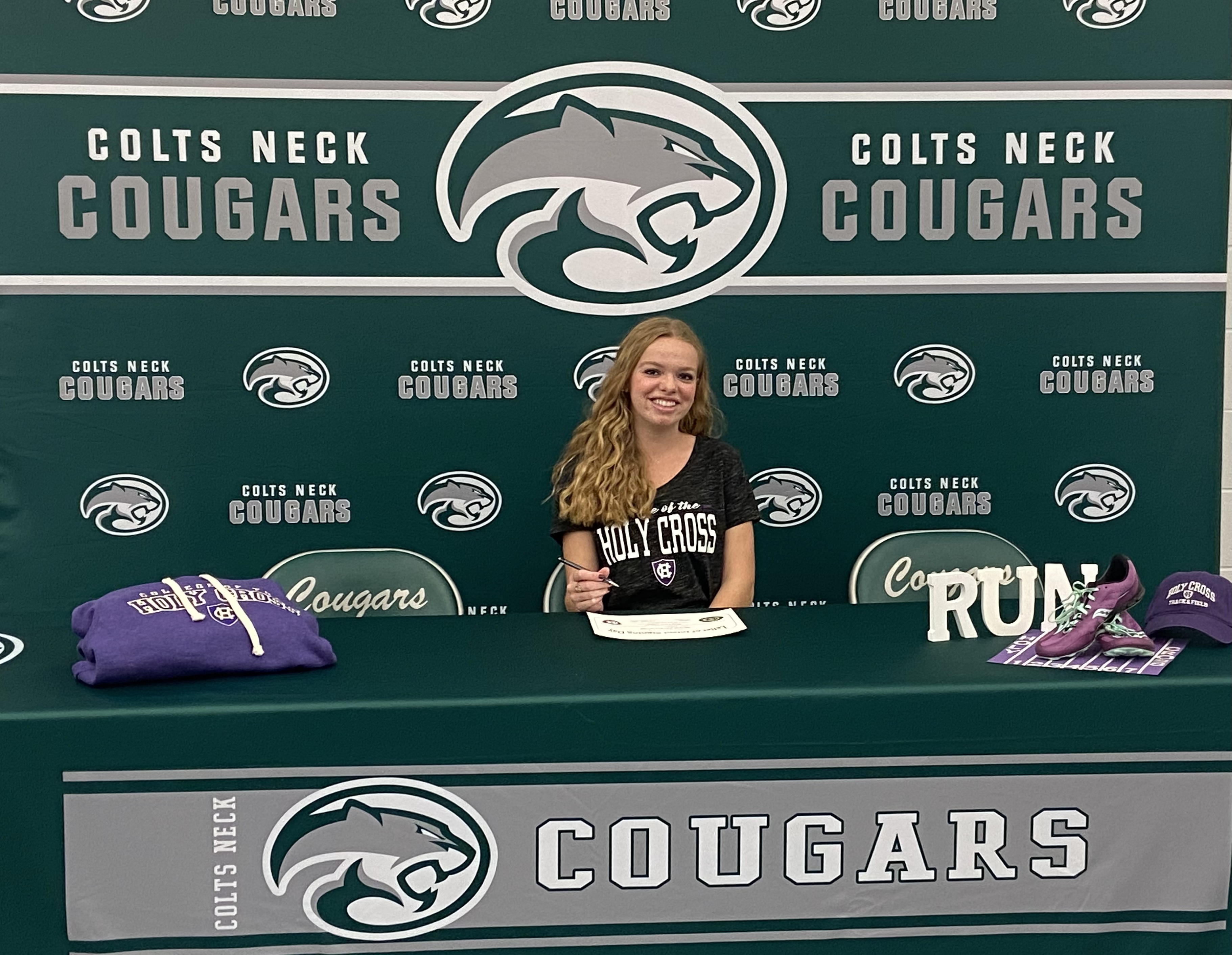 Olivia Petschauer from Colts Neck Girls Cross Country signs with Holy Cross.