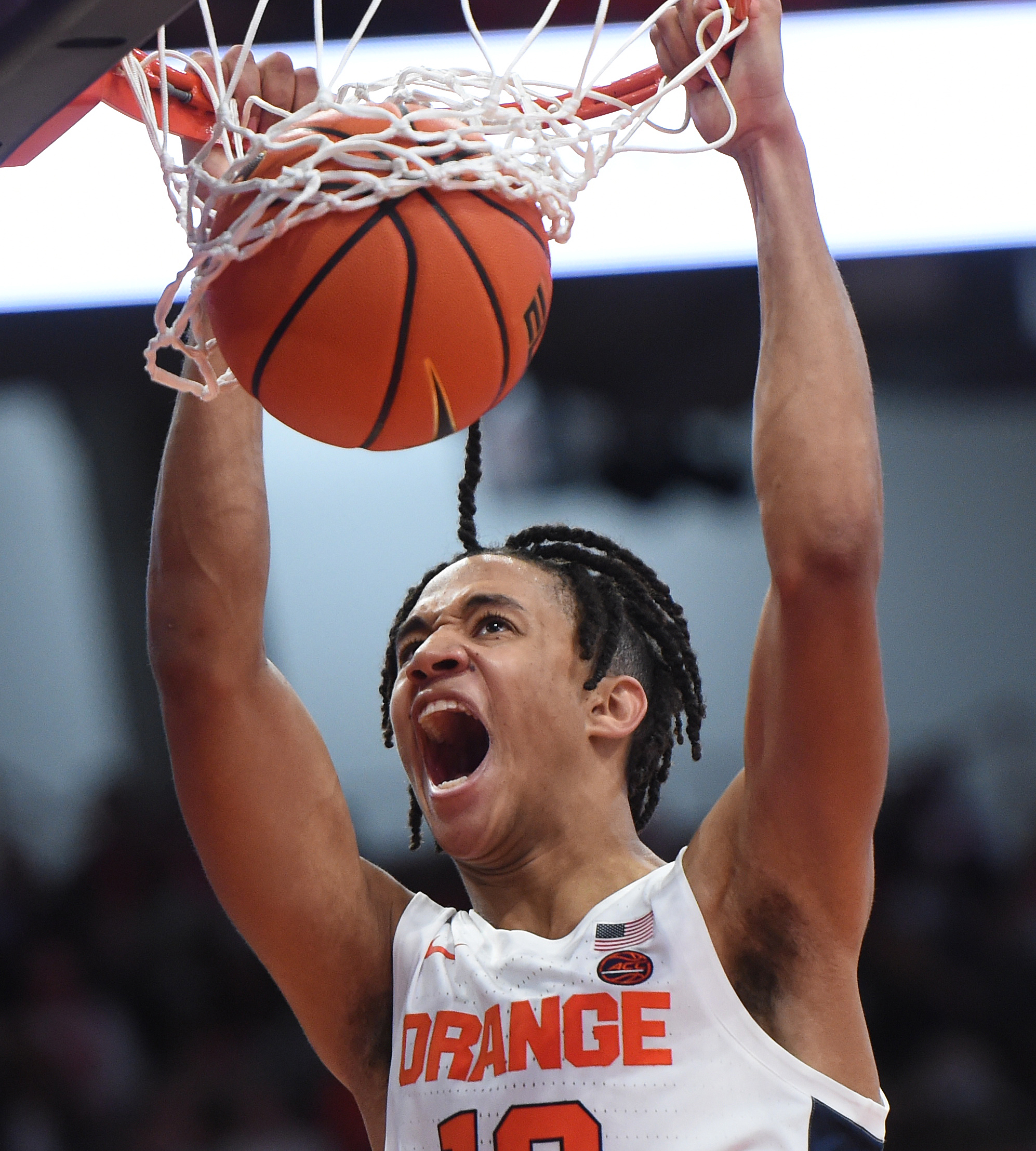 Syracuse forward Benny Williams, right, grabs a rebound in front