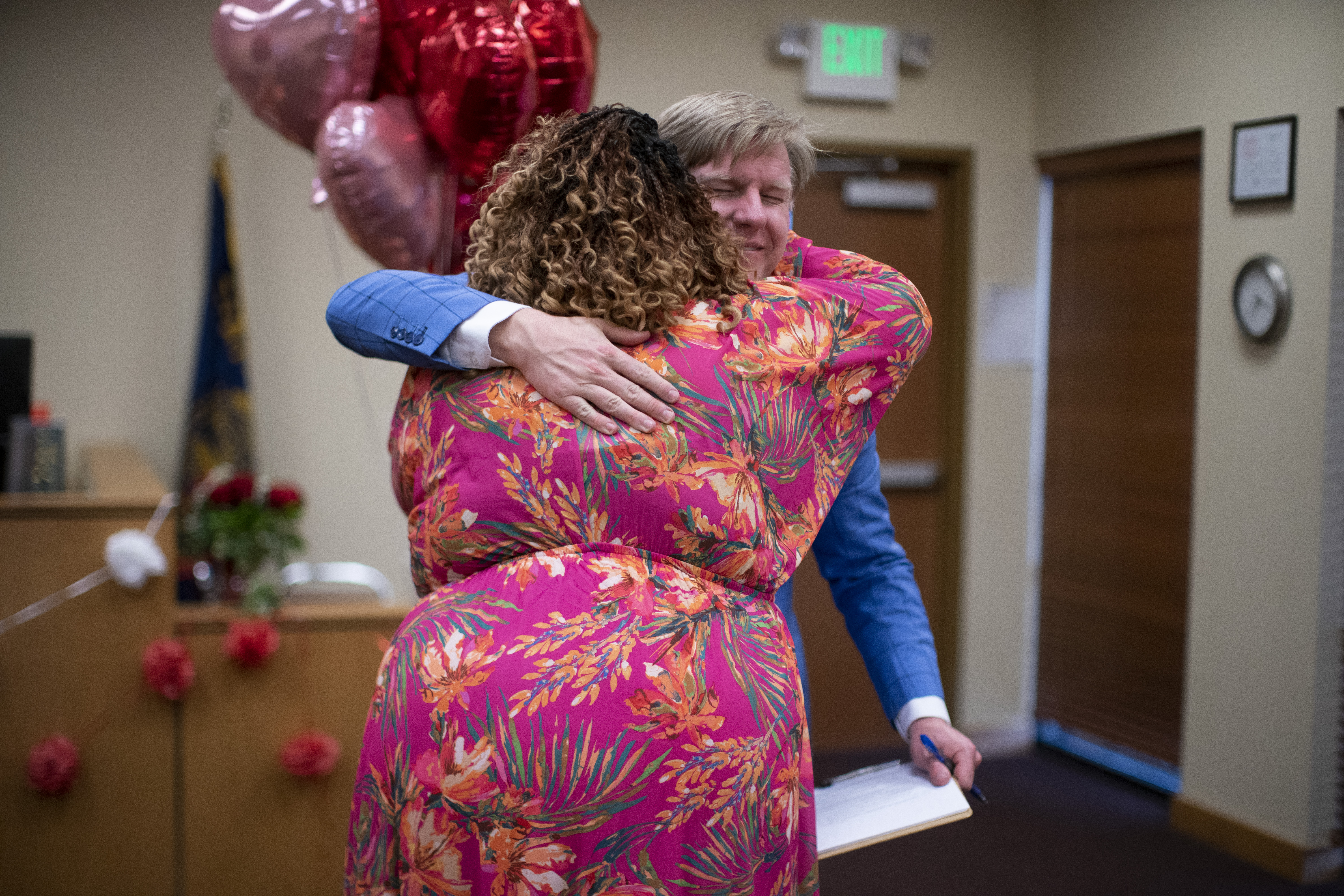 Sarah Smith embraces Justice of the Peace Justin Kidd after he officiated over her marriage to Giovani Emmanuel at the Marion County Justice Court in Salem, February 14, 2023. Beth Nakamura/The Oregonian