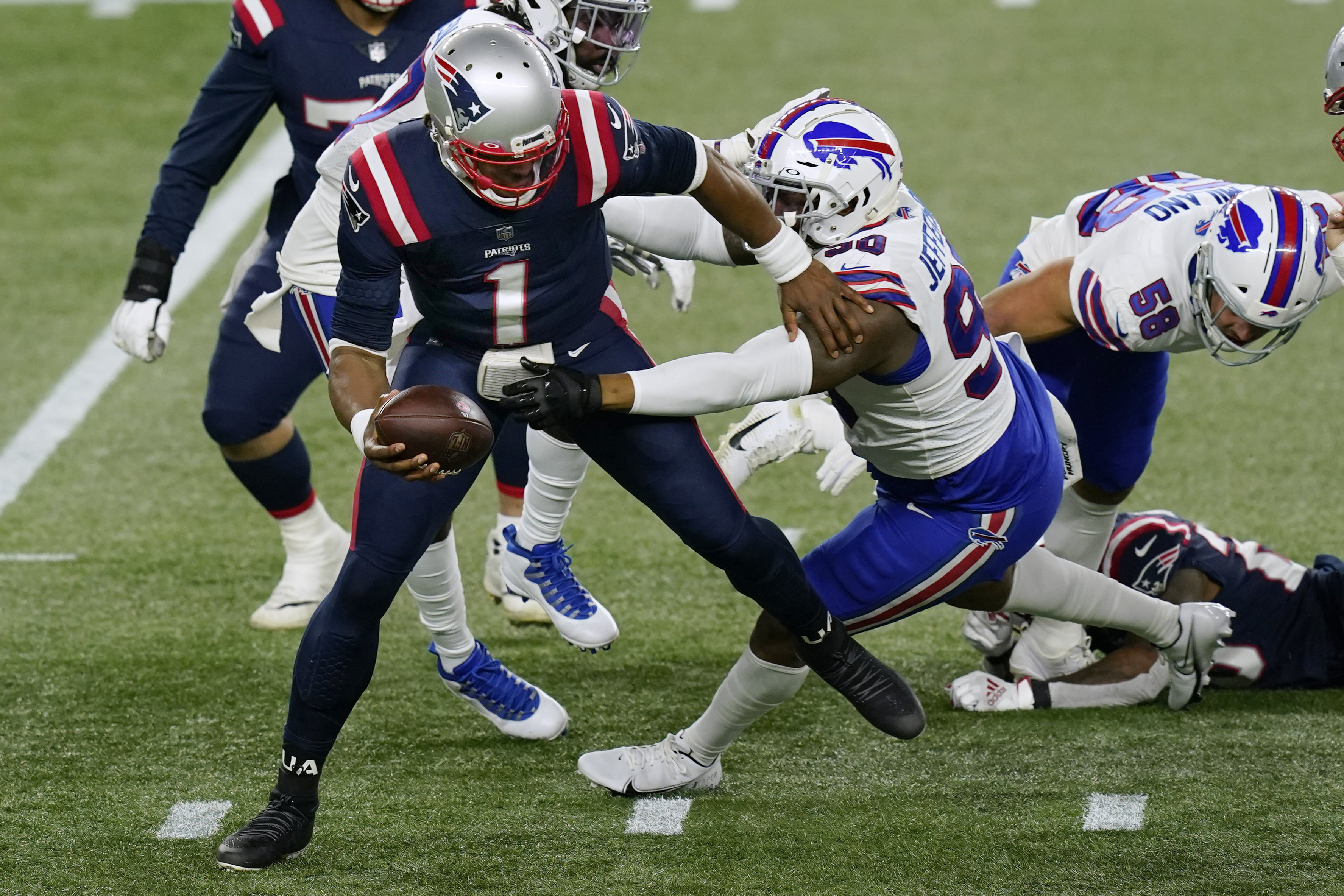 Josh Allen of the Buffalo Bills stiff-arms Jason McCourty of the