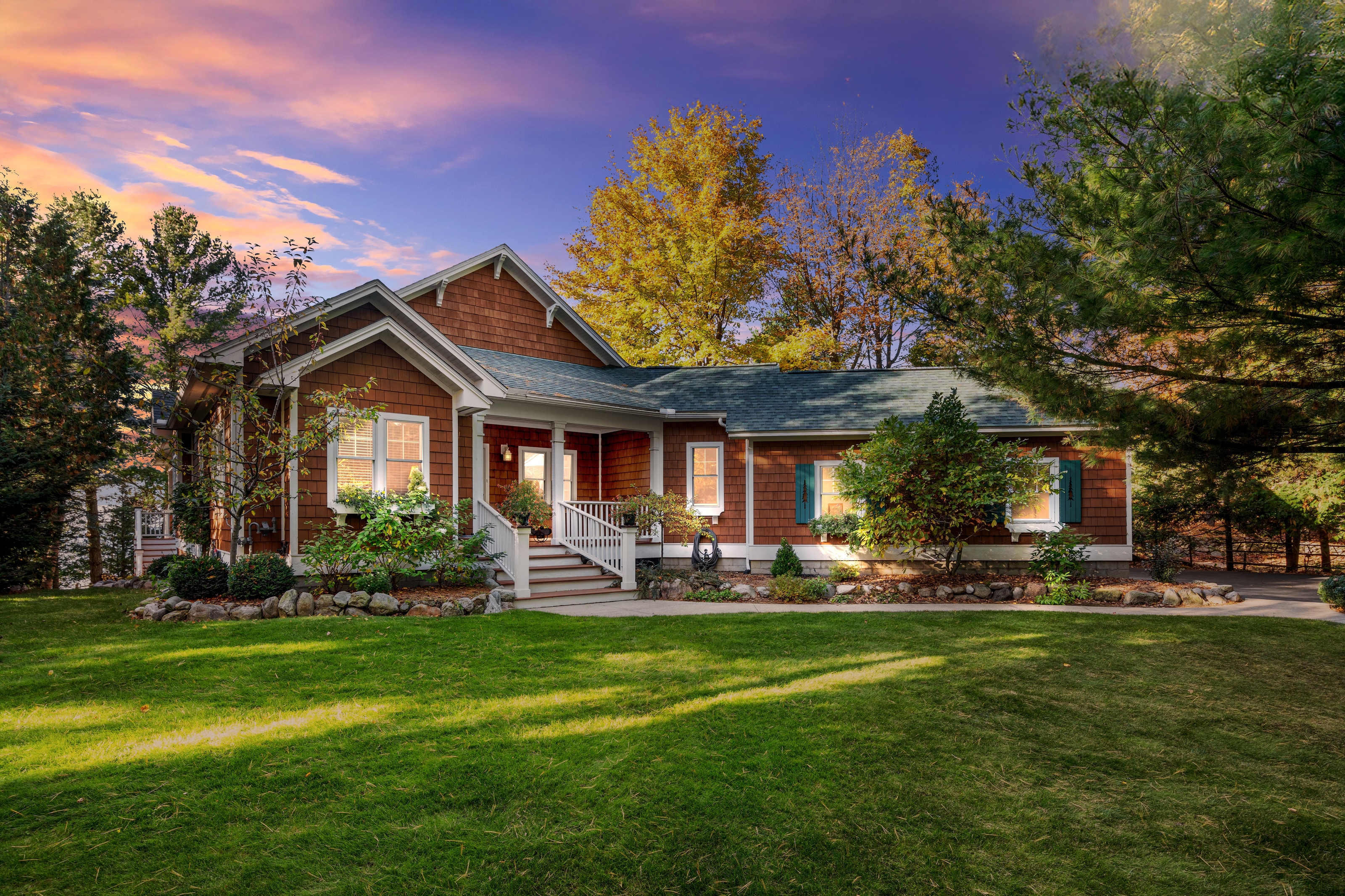 Exterior photographs of 4093 Lake Shore Drive in Charlevoix, this gem is listed at $2,099,900 through Berkshire Hathaway HomeServices Michigan Real Estate – Traverse City and The Crane Group with associate broker Johnny Crane and his brother, co-listing agent Matt Crane.