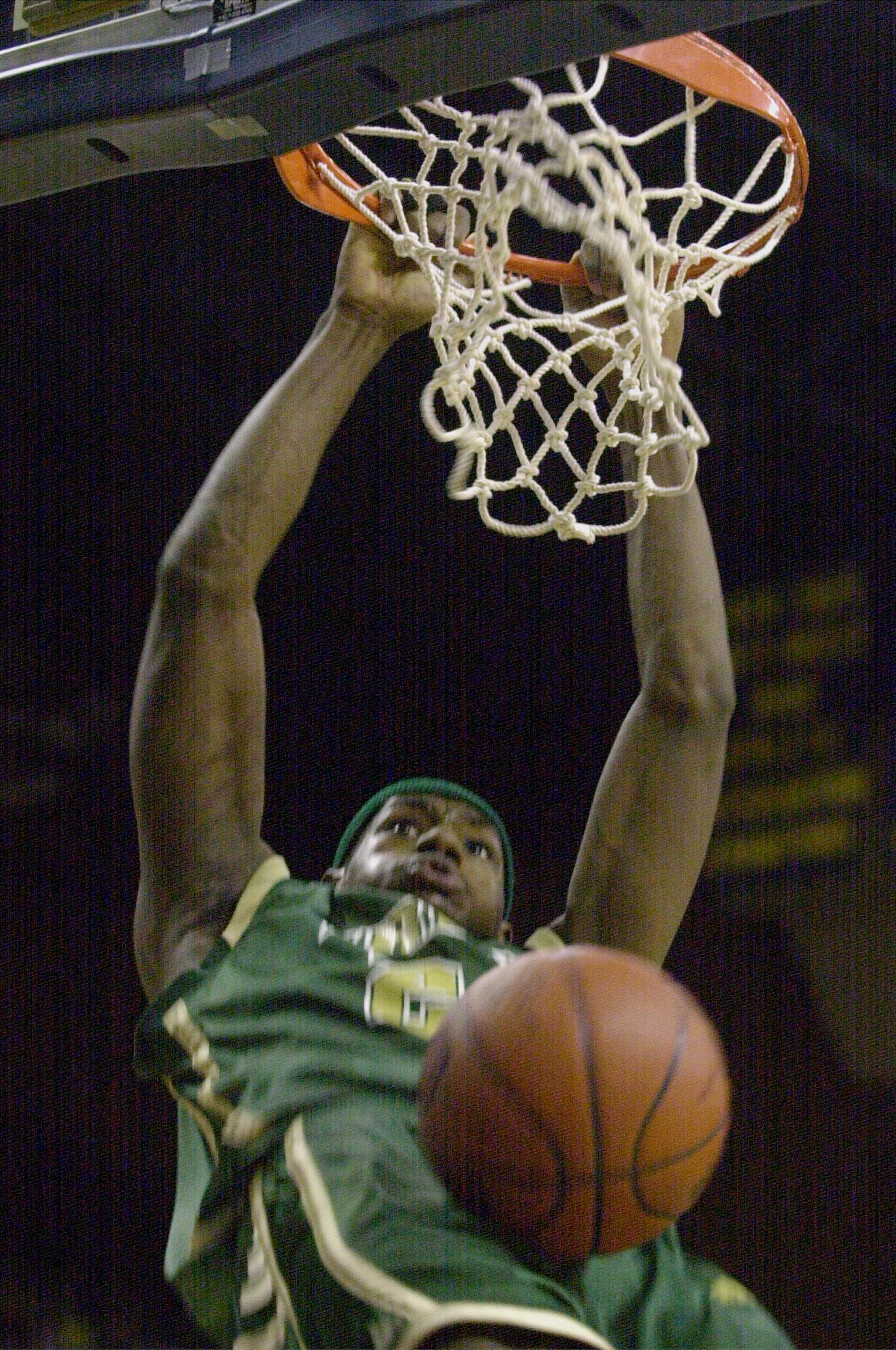 LeBron James, of Akron St. Vincent-St. Mary, slams down two points on a dunk in the first half Saturday, March 16, 2002.  SVSM defeated Ottawa-Glandorf in the regional final 77-58.