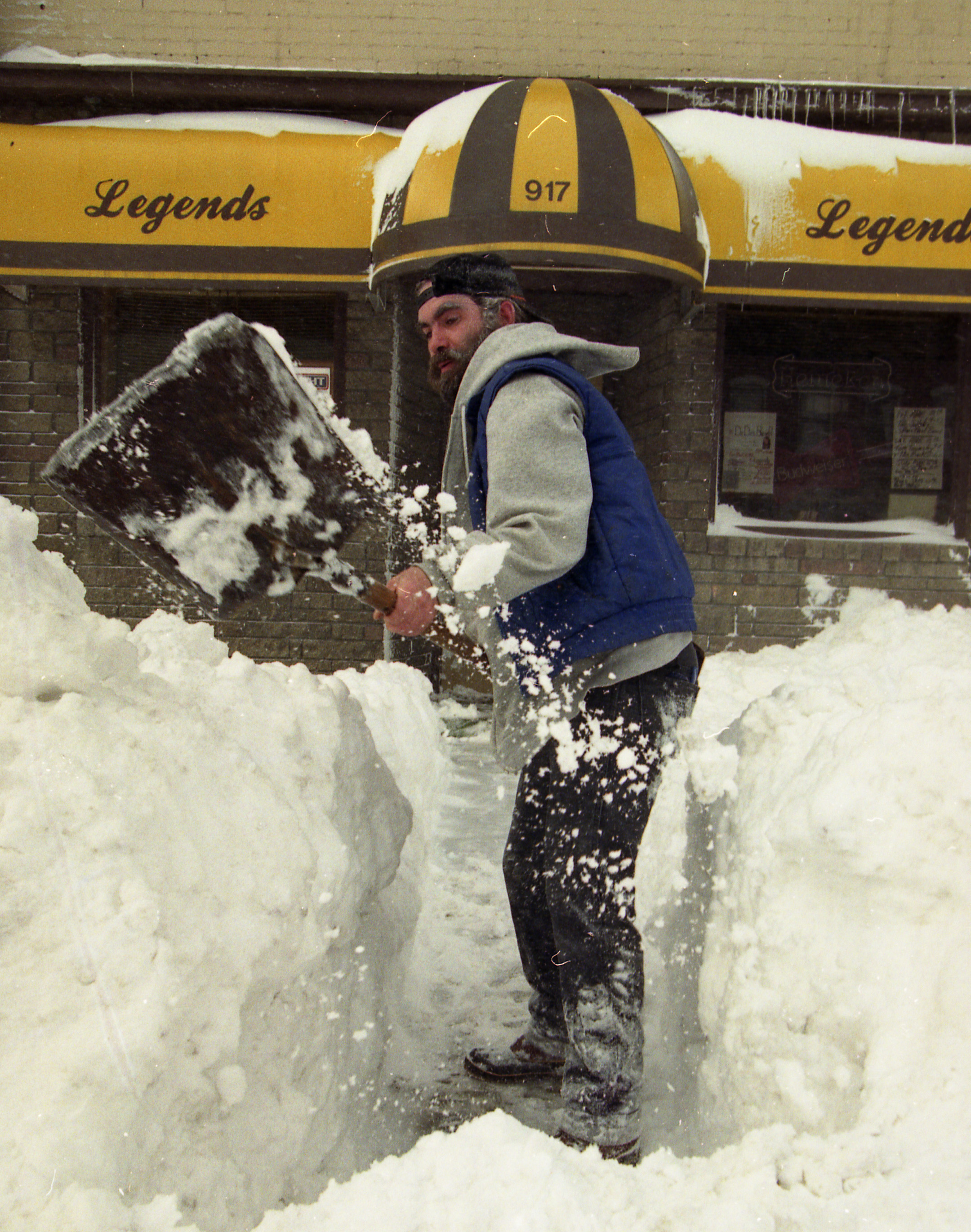 Scott McIntyre, who works at Legends Bikes 'N Blues Bar on North Salina Street in Syracuse digs out after the Blizzard of '93.