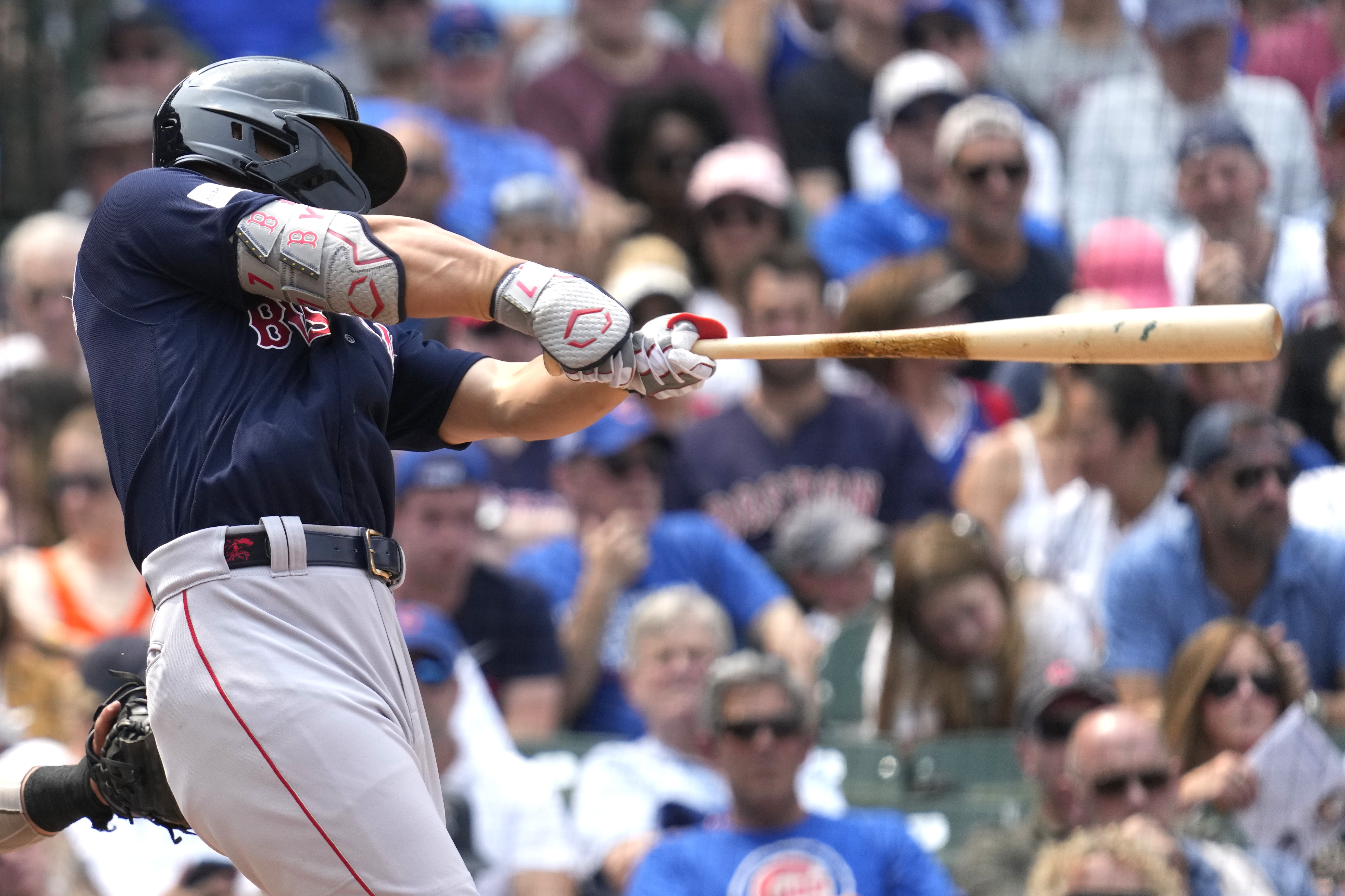 Minneapolis, Minnesota, on June 20, 2023. Masataka Yoshida of the Boston  Red Sox is congratulated by teammates in the dugout after hitting a two-run  home run in the eighth inning of a