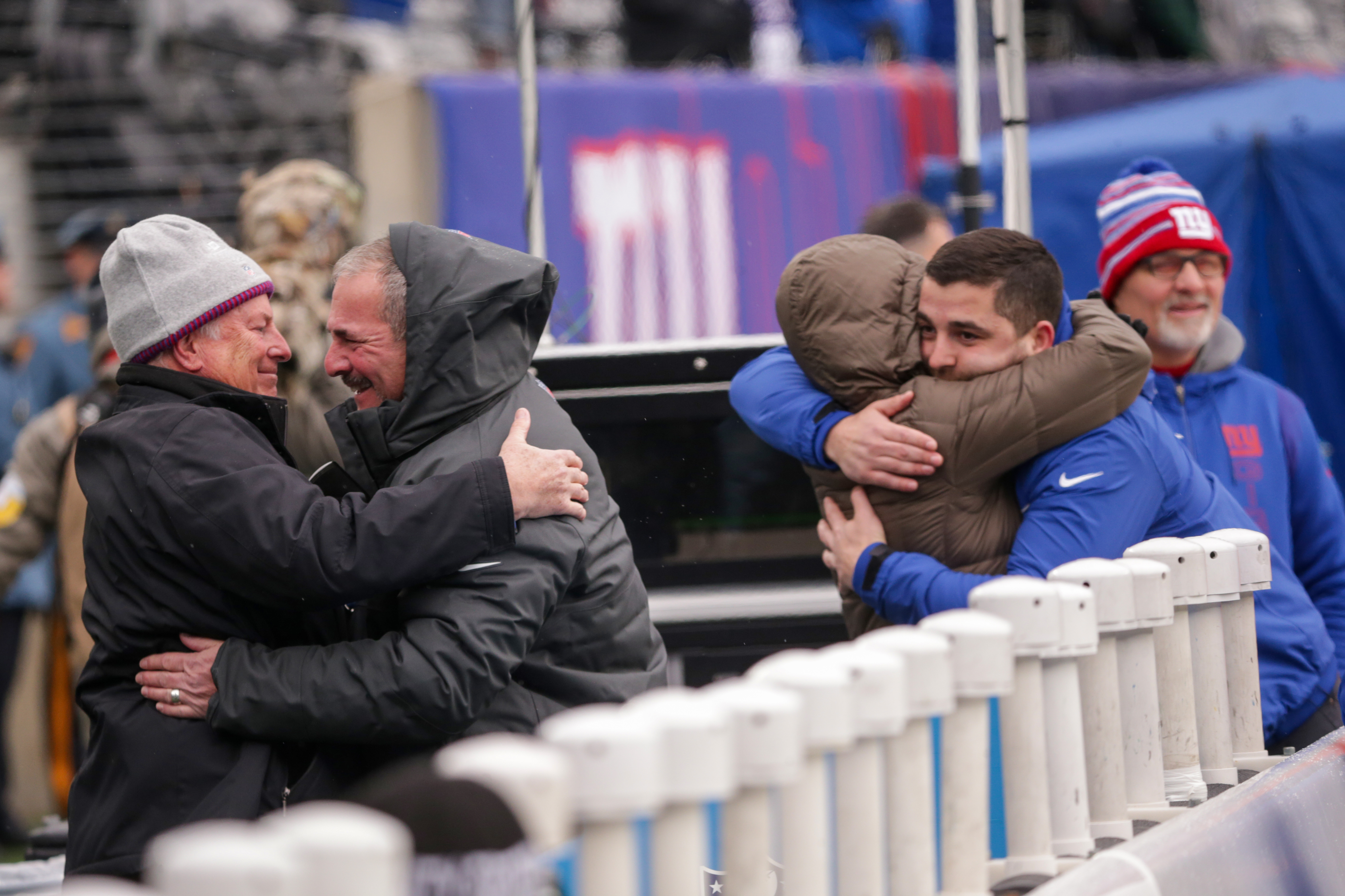 New York Giants general manager Dave Gettleman and his wife, Joanne, are embraced by friends and team personnel during pregame warmups as the Giants prepare to host the Washington Football Team on Sunday, Jan. 9, 2022 in East Rutherford, N.J.