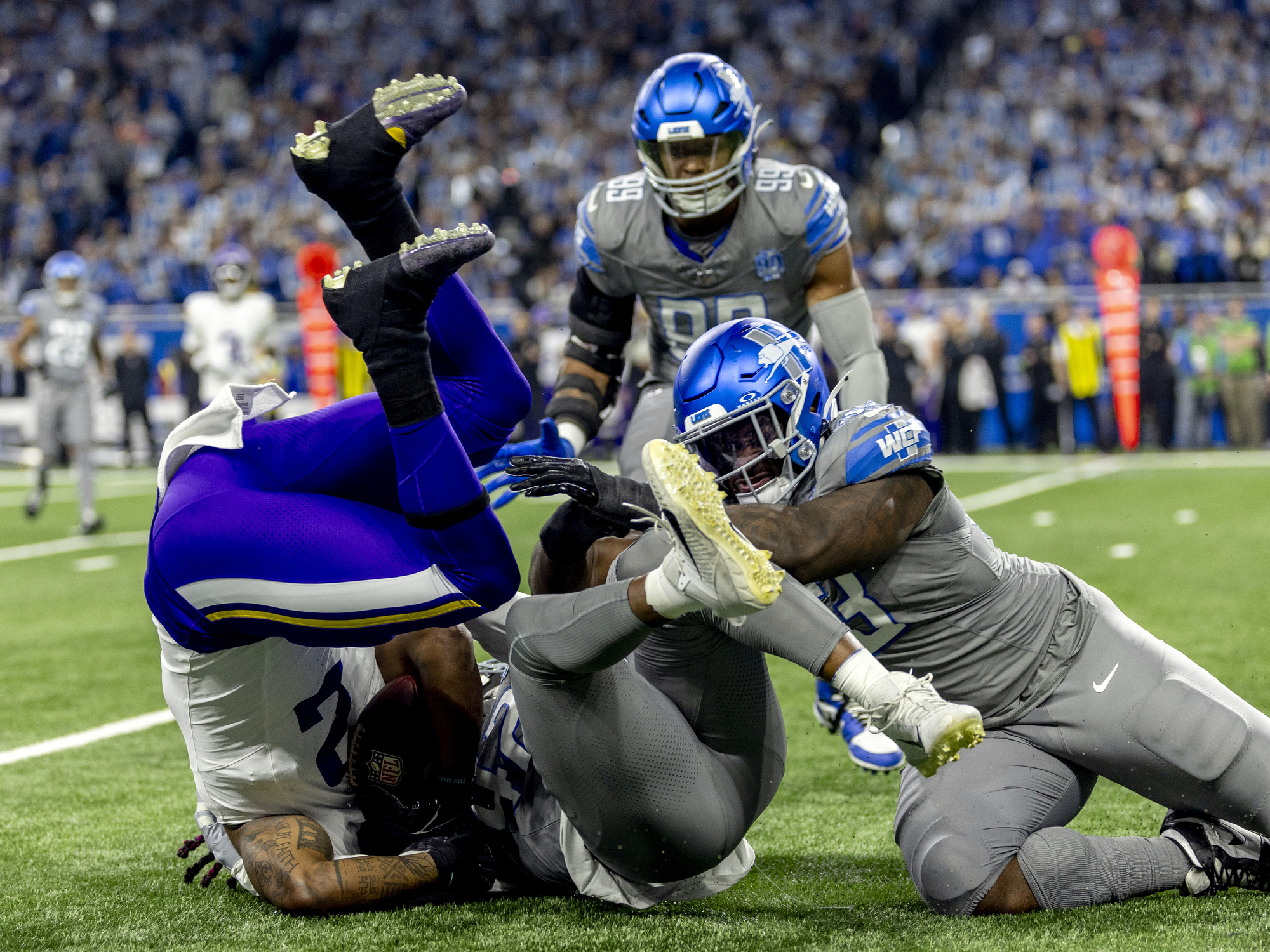 Detroit Lions linebacker Jalen Reeves-Maybin outmuscles Minnesota Vikings running back Alexander Mattison, tackling him hard to the ground during the first half in last regular season game on Sunday, Jan. 7, 2024 at Ford Field in Detroit.