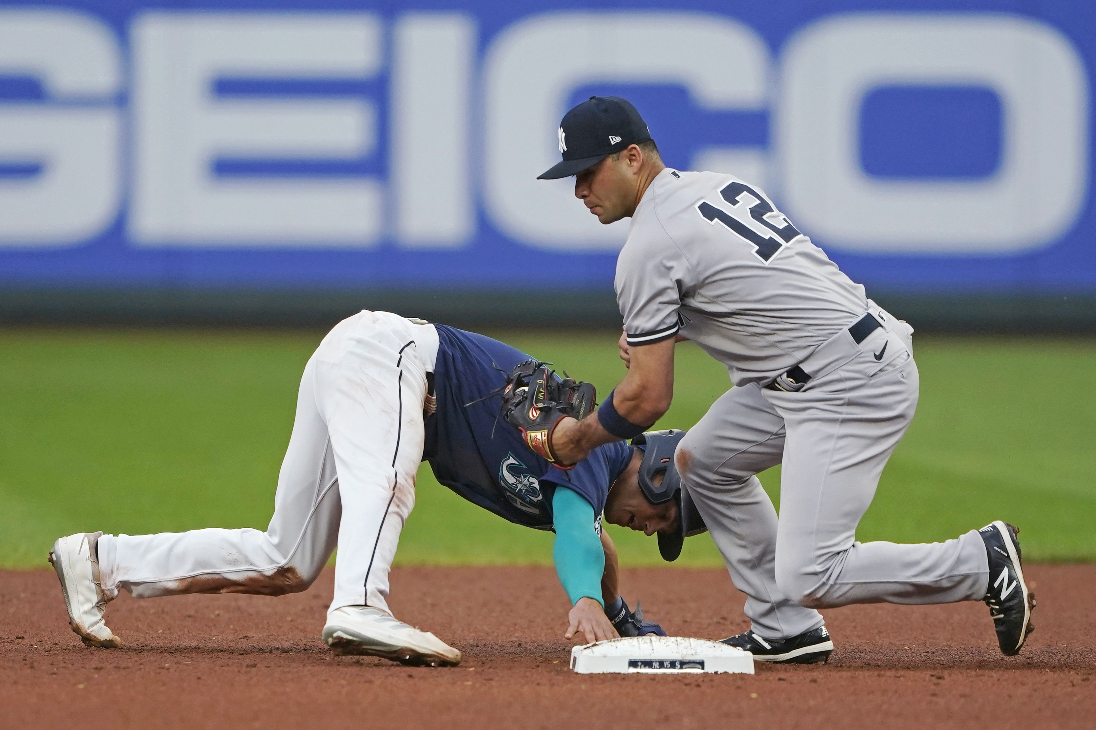 Mariners pitcher Paul Sewald reacts to Blue Jays merchandise being