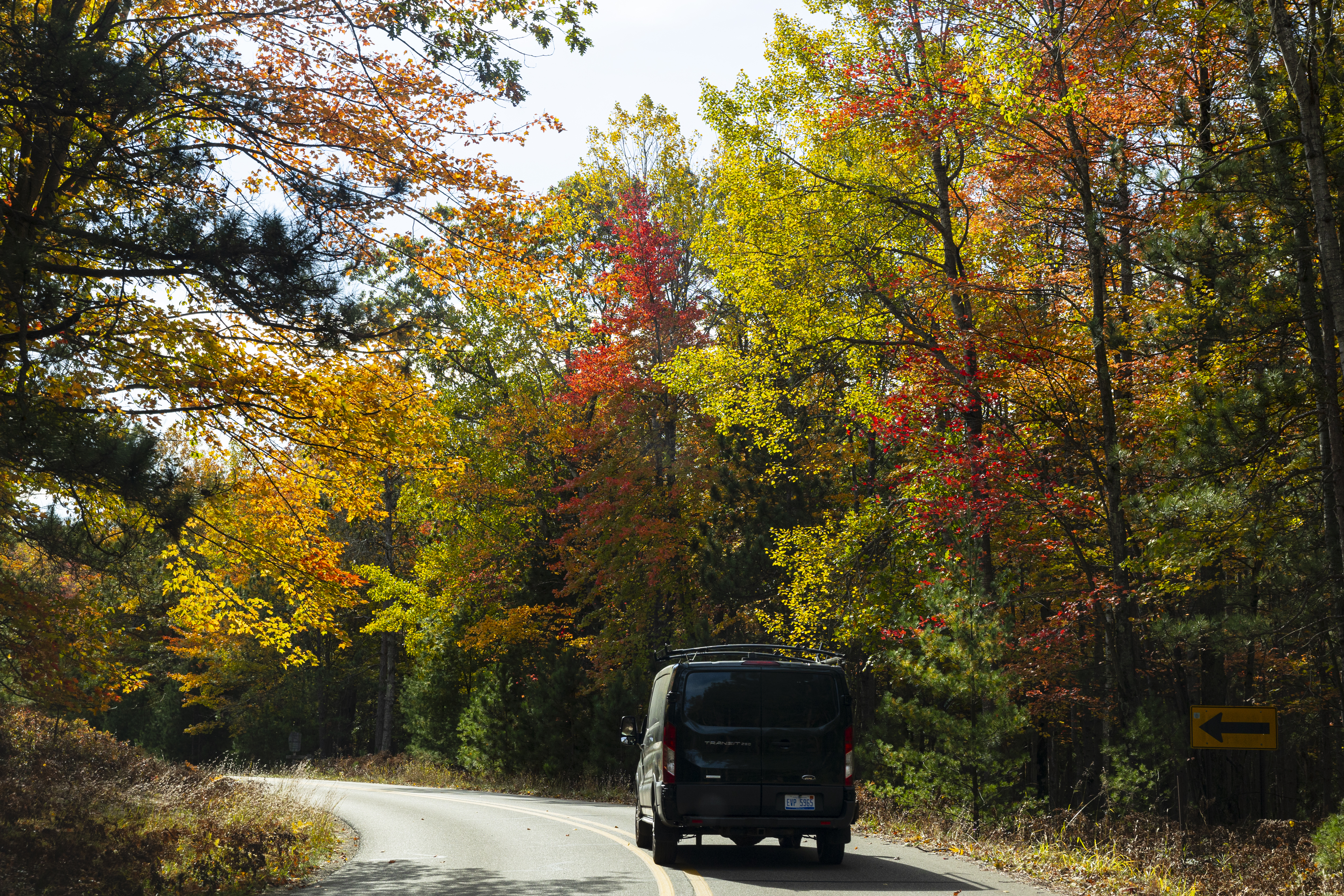 A vehicle drives along Porter Creek Road in Nordhouse Dunes Wilderness Area in Mason County, Mich. on Saturday, Oct. 12, 2024.  