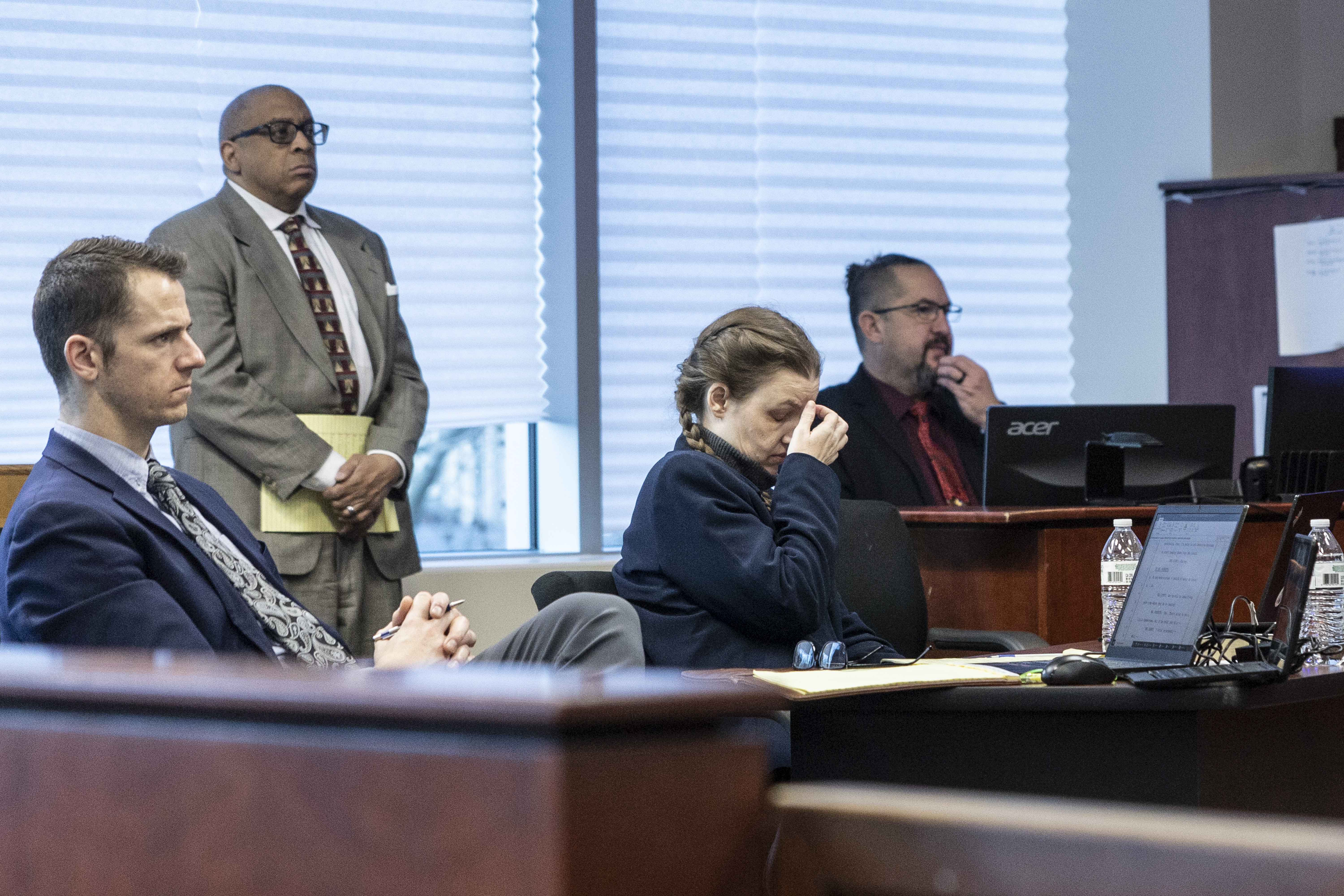 Shanda Vander Ark, 44, touches her face during opening statements at the Muskegon County Courthouse on Wednesday, Dec. 13, 2023.