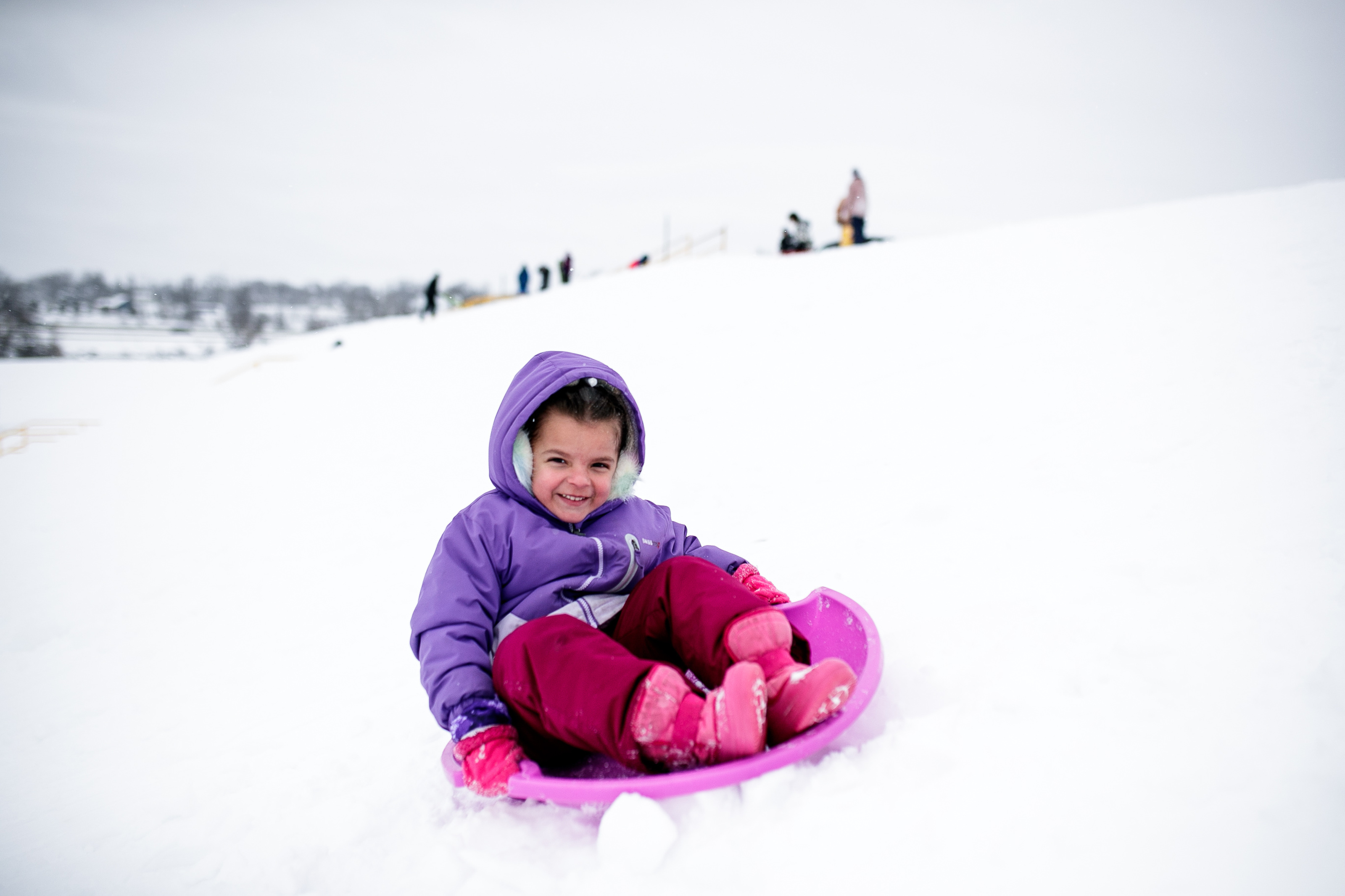 Families enjoy the snow, sledding hill at Flint Southwestern Classical ...