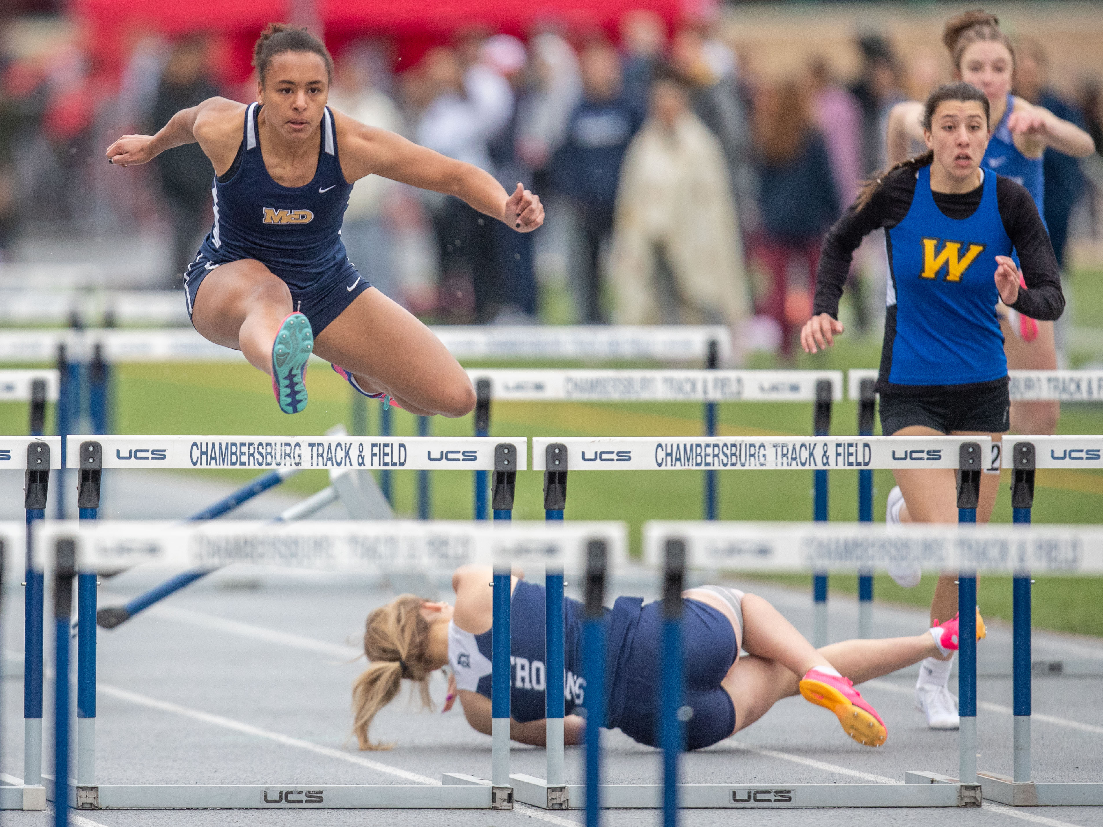 Maddy Brooks, Bishop McDevitt, wins the 100m hurdles, as Chambersburg’s Ella Fatyol takes a tumble, in the 2023 Tim Cook Memorial Invitational track & field meet at Chambersburg, Pa., Mar. 25, 2023.Mark Pynes | pennlive.com