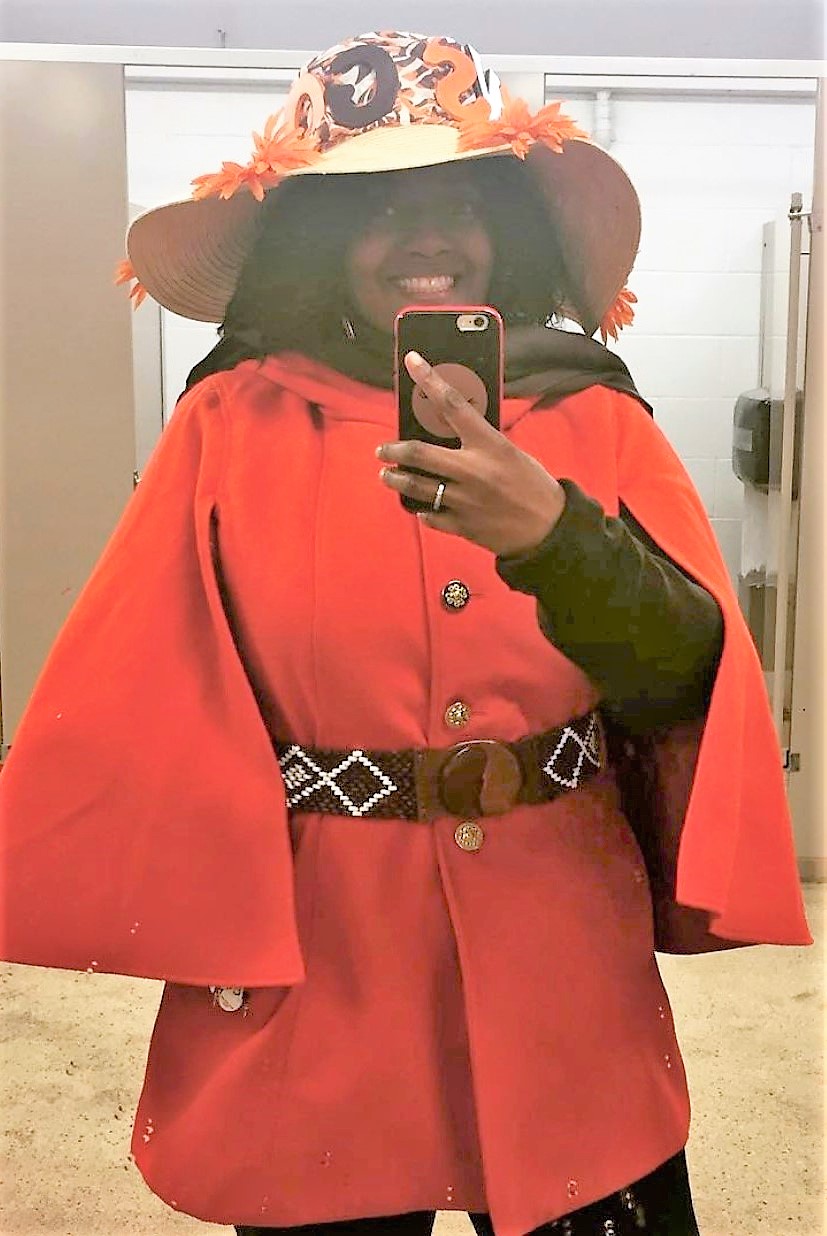 A man dons Cleveland Browns attire while draped in Browns trinkets