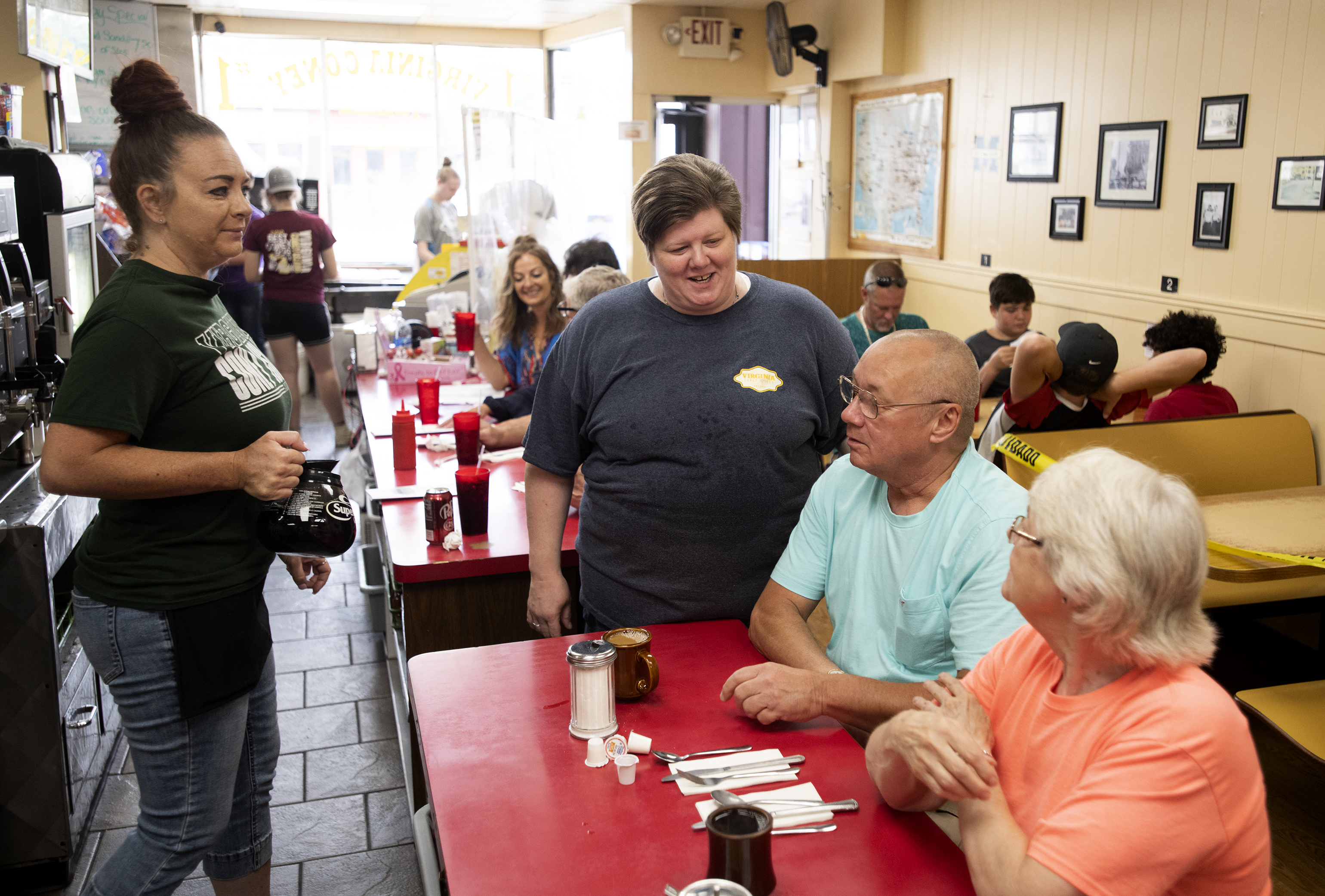 Co-owner Erin Matthews, middle, talks with customers at Virginia Coney Island on Monday, July 6, 2020. The restaurant has been serving the Jackson community since 1914.