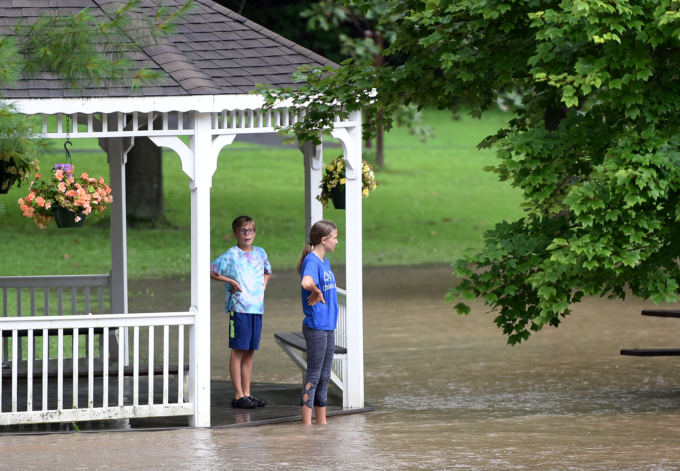 Folks walks out to the gazebo at Marcellus Park the look at the flooded Ninemile Creek. Heavy rains again created flooding in Central New York August 19, 2021, with much of the flooding occurring along Ninemile Creek in Camillus and Marcellus. Dennis Nett | dnett@syracuse.com