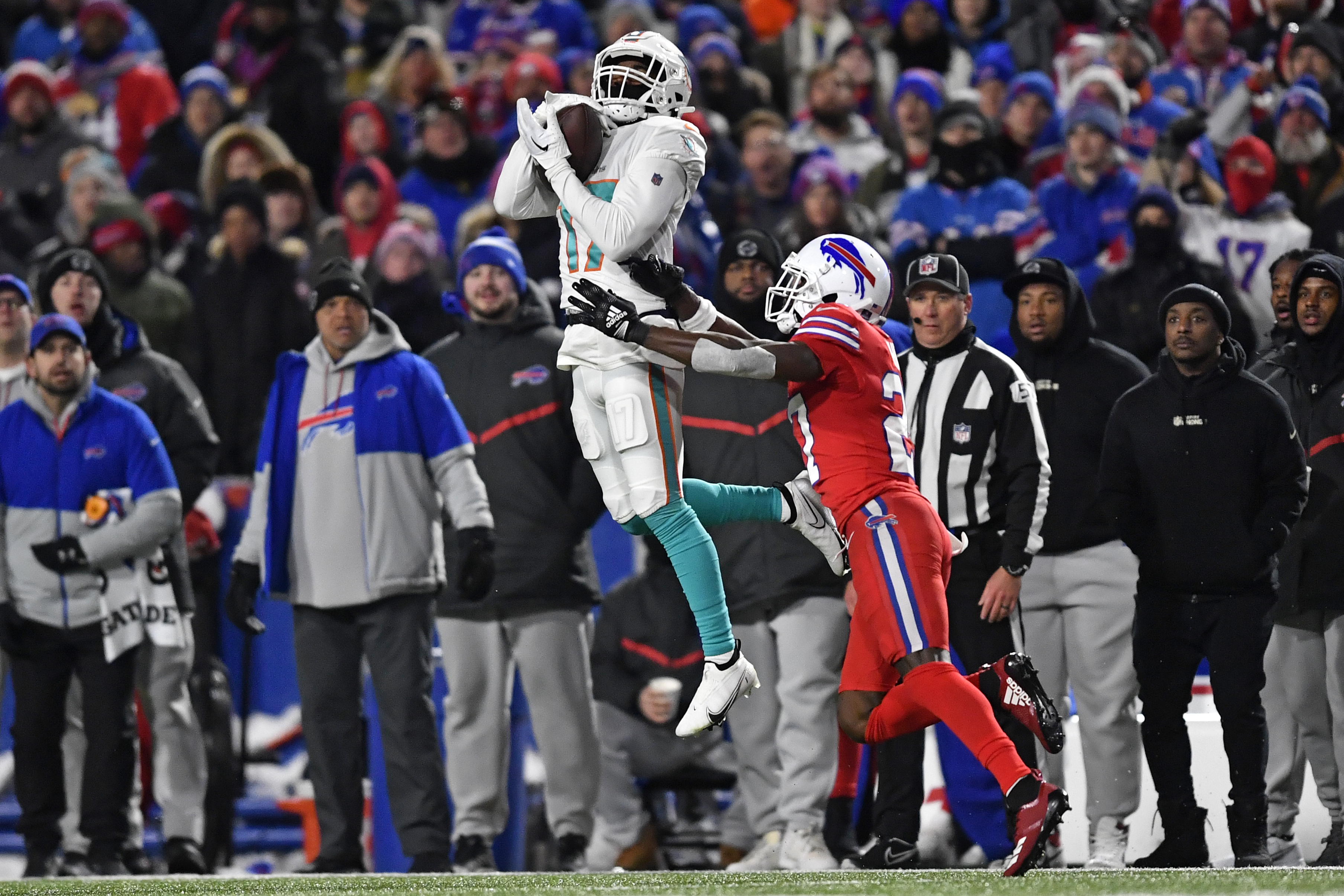 Miami Dolphins wide receiver Jaylen Waddle (17) catches a pass Buffalo Bills  cornerback Tre'Davious White (27) during second quarter of an NFL football  game at Highmark Stadium on Saturday, Dec. 17, 2022